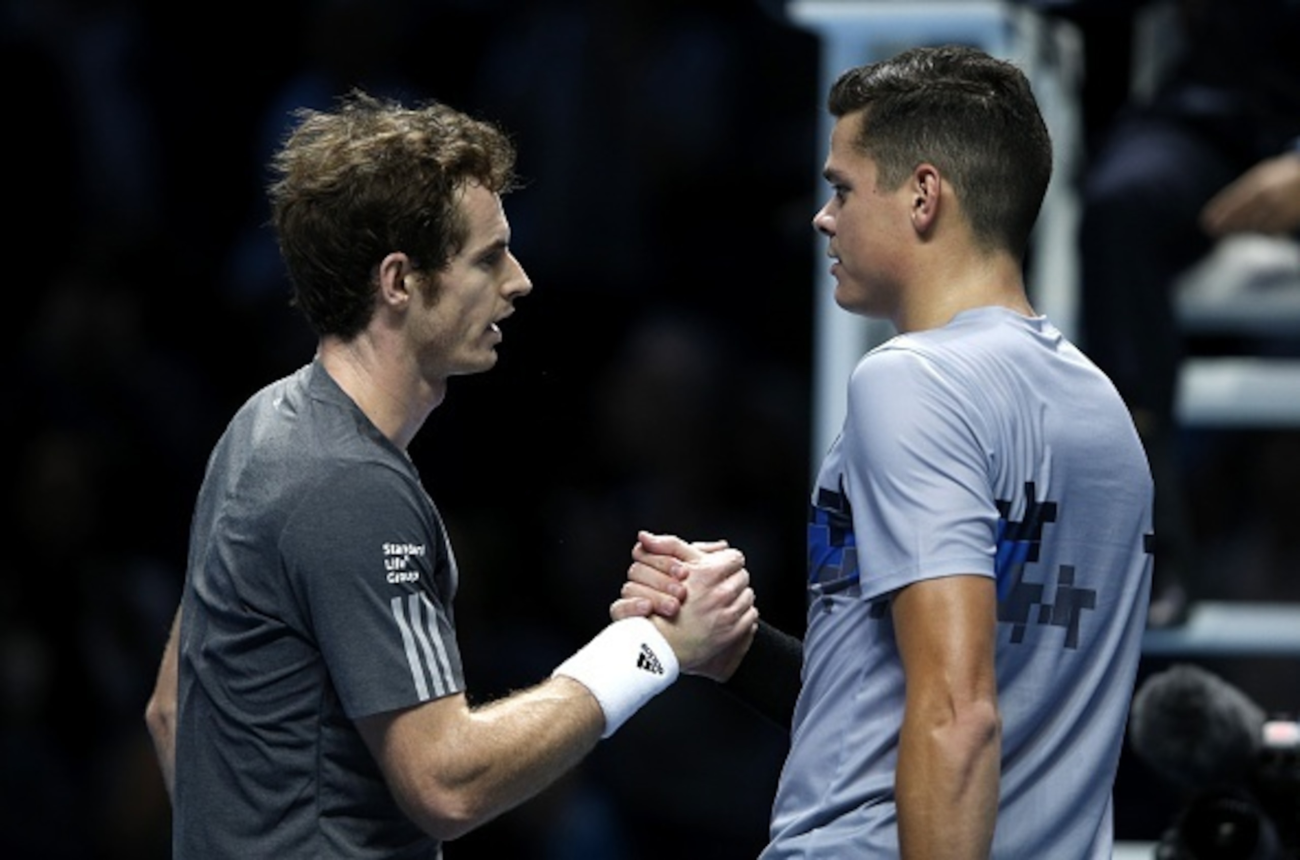 Andy Murray and Milos Raonic shake hands at the 2014 ATP World Tour finals.