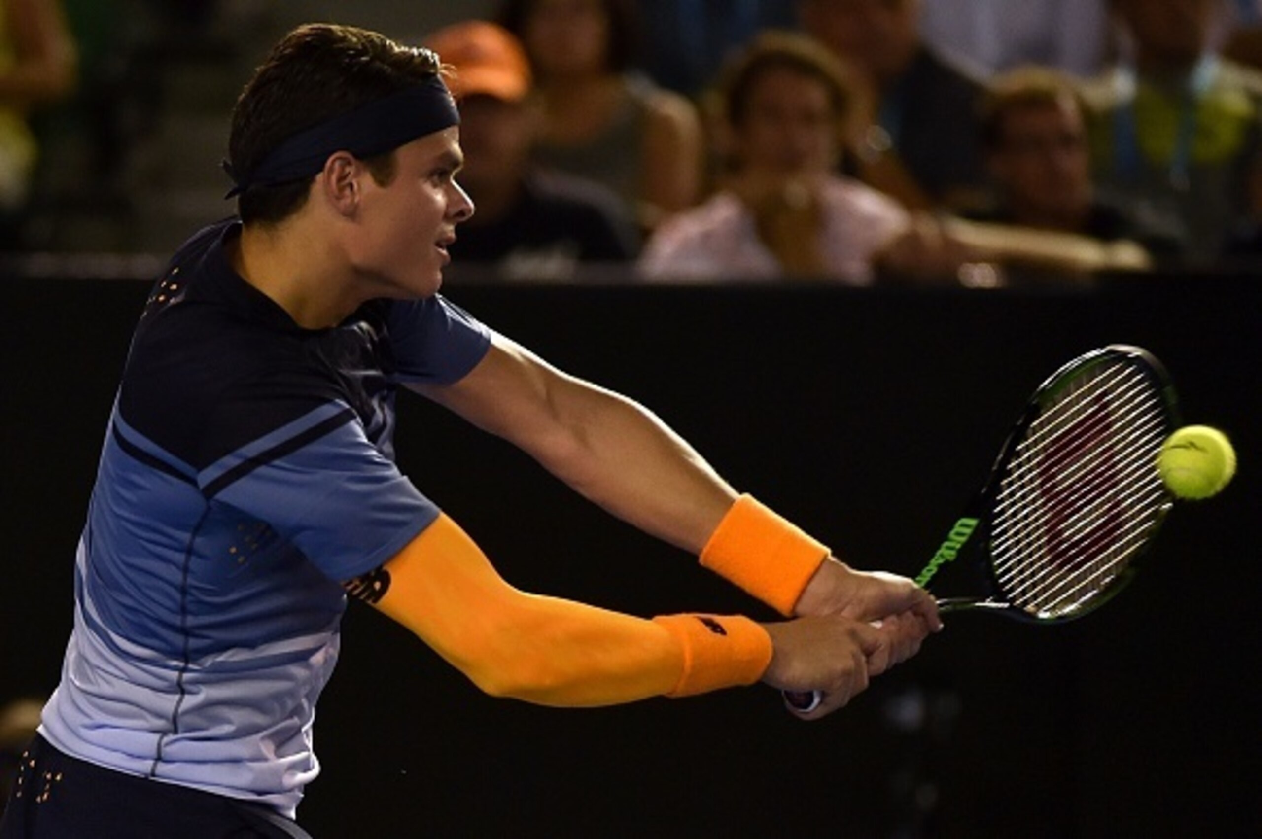 Milos Raonic hits a backhand during his quarterfinals match at the 2016 Australian Open.