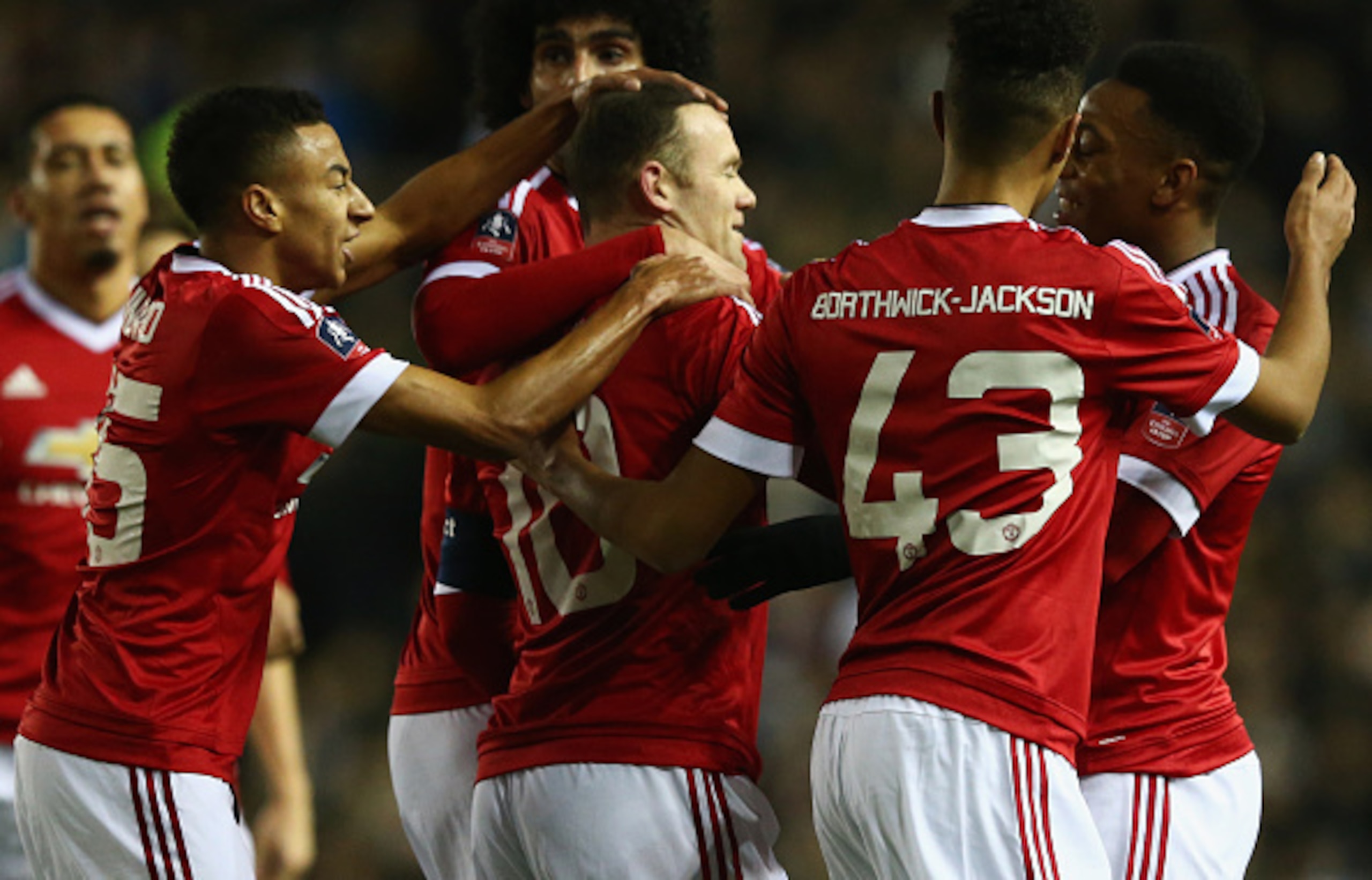 Rooney is congratulated on his goal against Derby.
