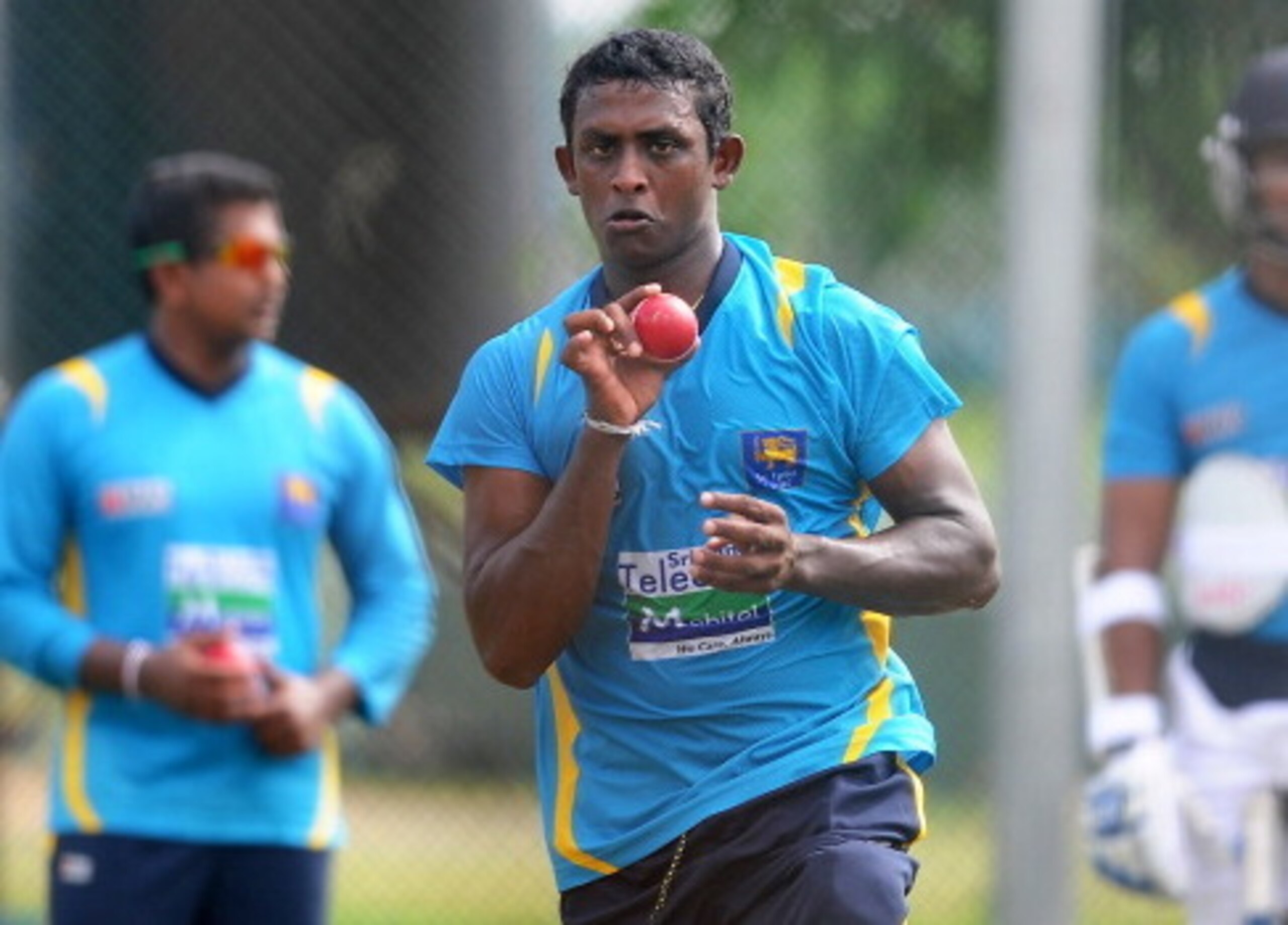 Ajantha Mendis flicks the ball out of the front of his hand.