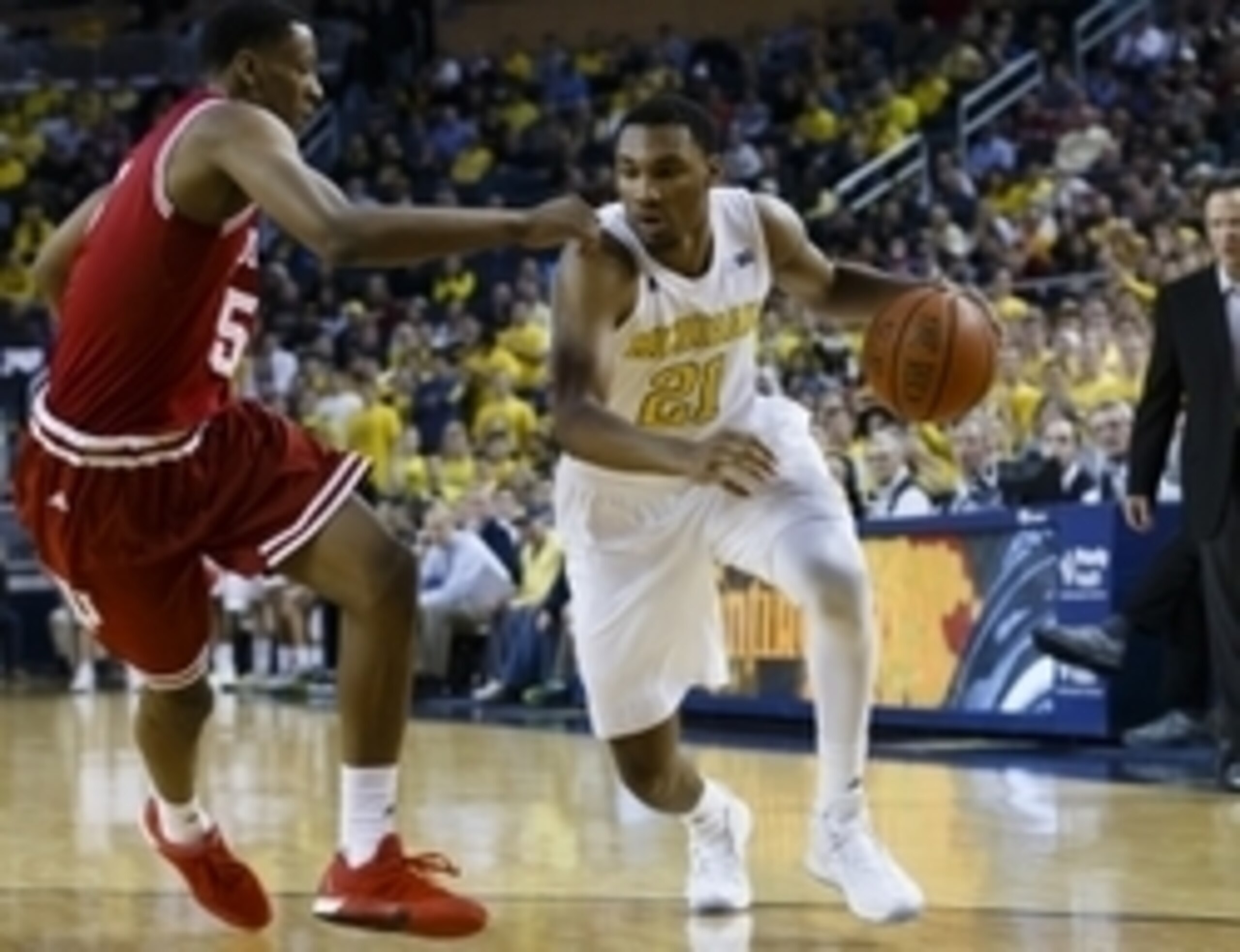 Feb 2, 2016; Ann Arbor, MI, USA; Michigan Wolverines guard Zak Irvin (21) moves the ball defended by Indiana Hoosiers forward Troy Williams (5) in the first half at Crisler Center. Mandatory Credit: Rick Osentoski-USA TODAY Sports Feb 2, 2016; Ann Arbor, MI, USA; Michigan Wolverines guard Zak Irvin (21) moves the ball defended by Indiana Hoosiers forward Troy Williams (5) in the first half at Crisler Center. Mandatory Credit: Rick Osentoski-USA TODAY Sports