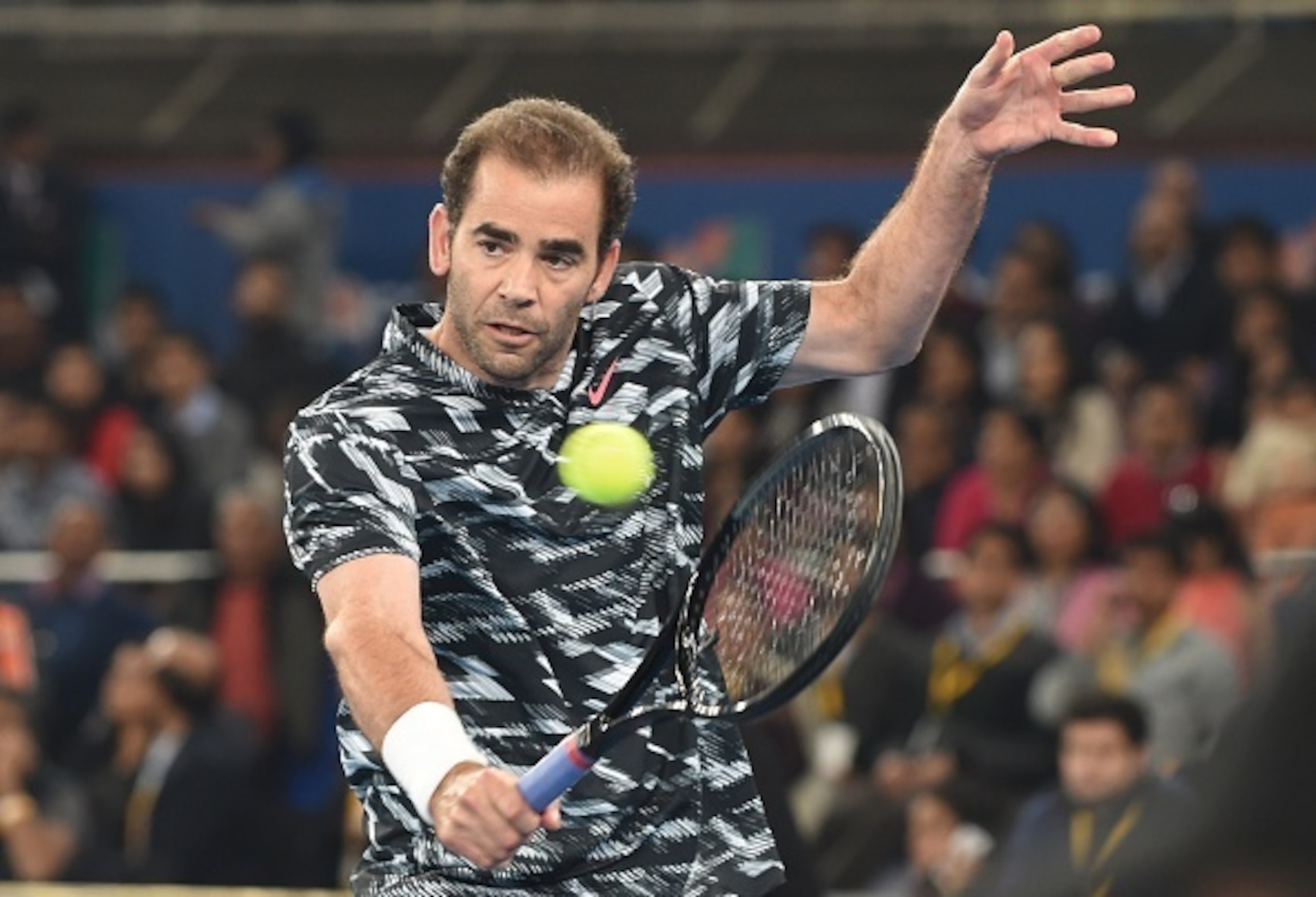 Pete Sampras hits a backhand during the 2014 IPTL season.