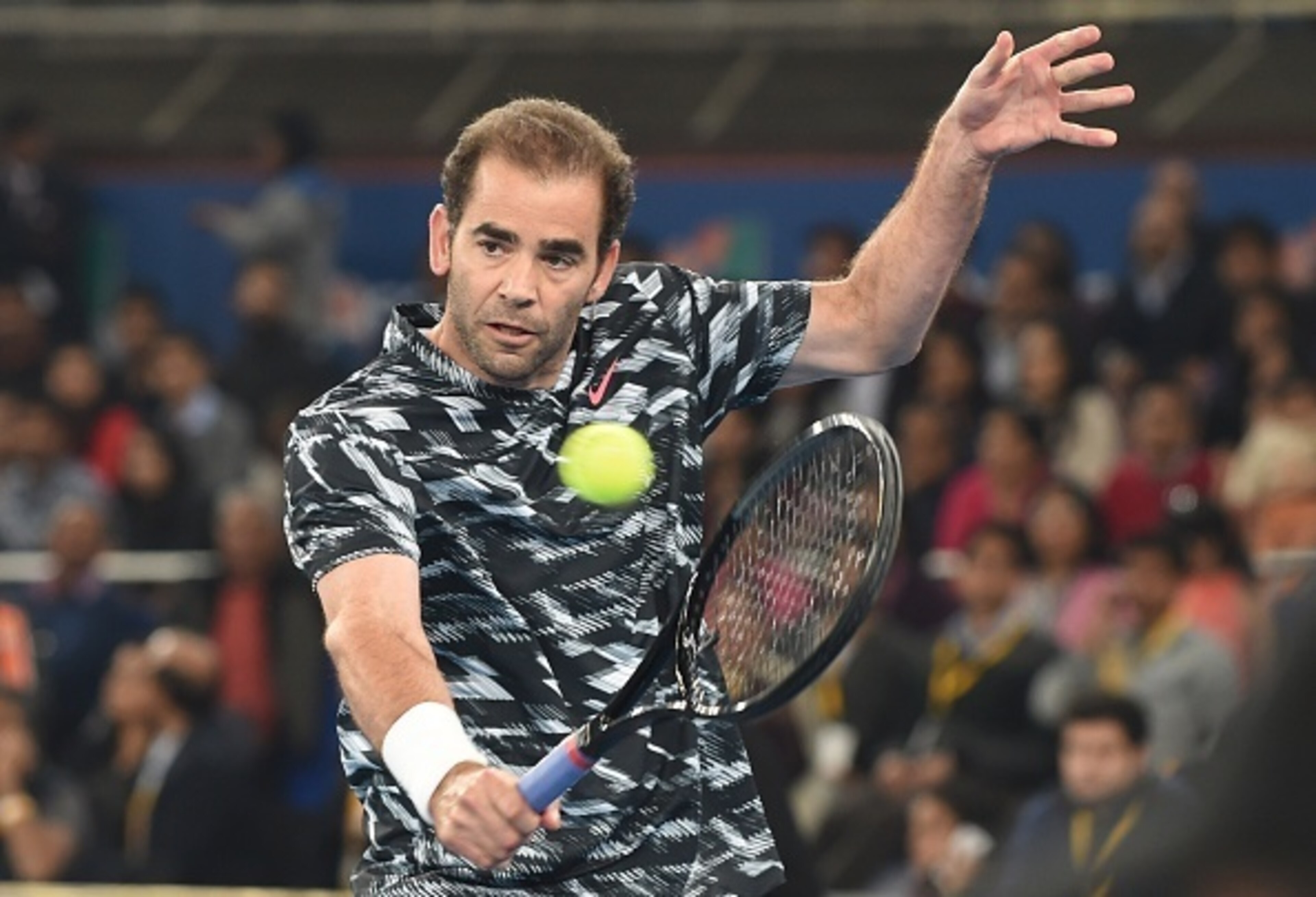 Pete Sampras hits a backhand during the 2014 IPTL season.