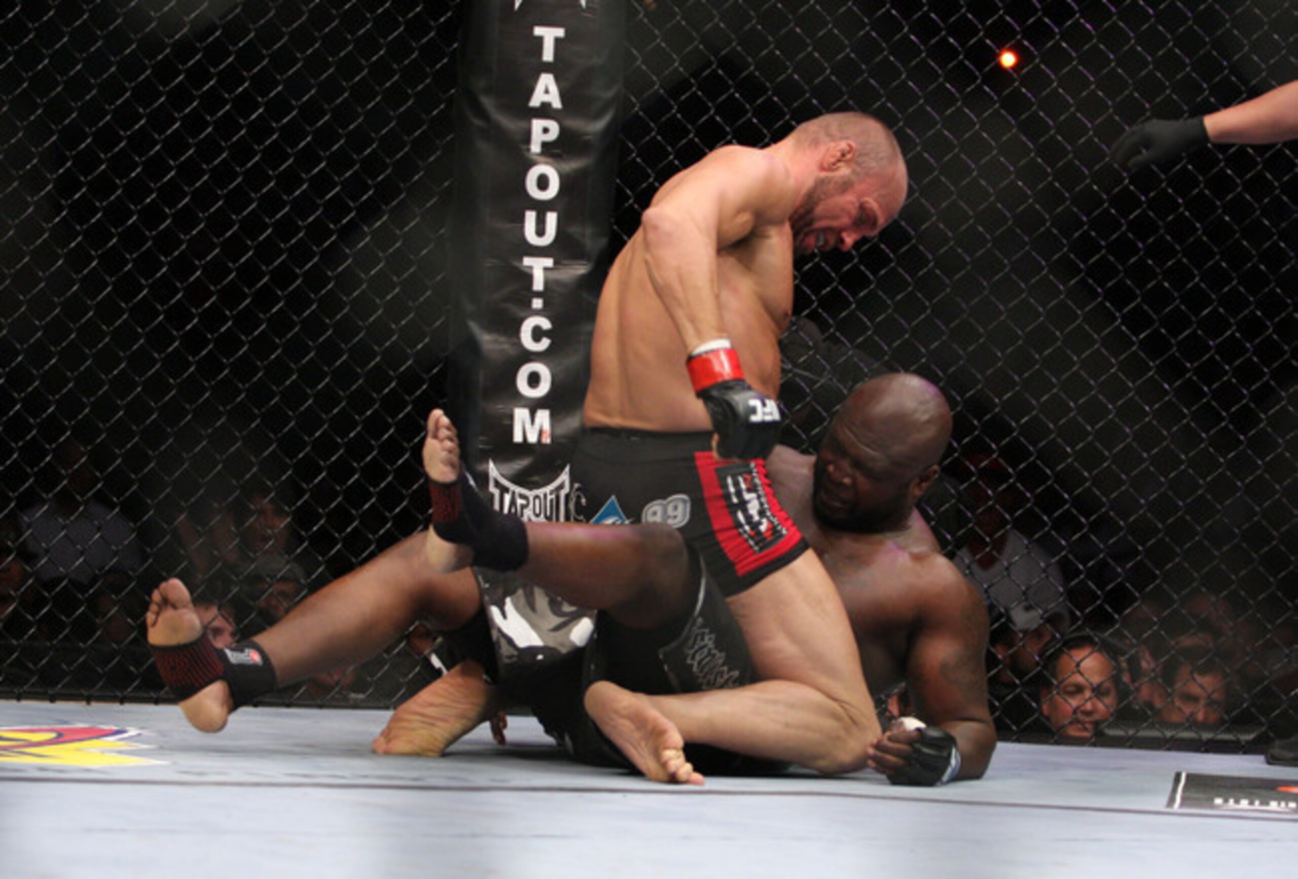 Randy Couture (top) punches James Toney.