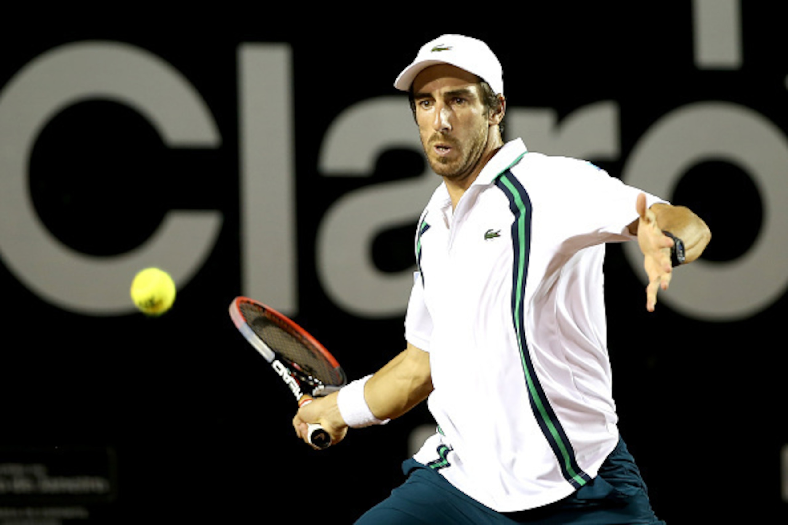 Pablo Cuevas slips past Guido Pella at Rio de Janeiro.