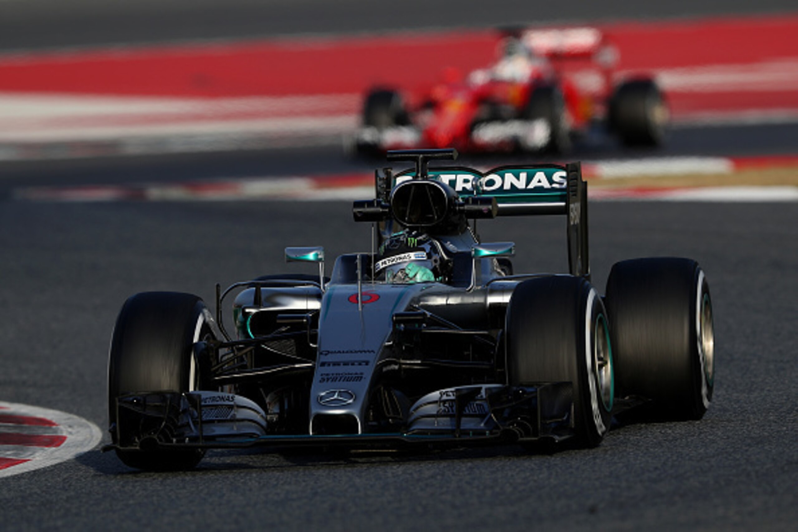 Sebastian Vettel follows Nico Rosberg at the Circuit de Catalunya. Sebastian Vettel follows Nico Rosberg at the Circuit de Catalunya.