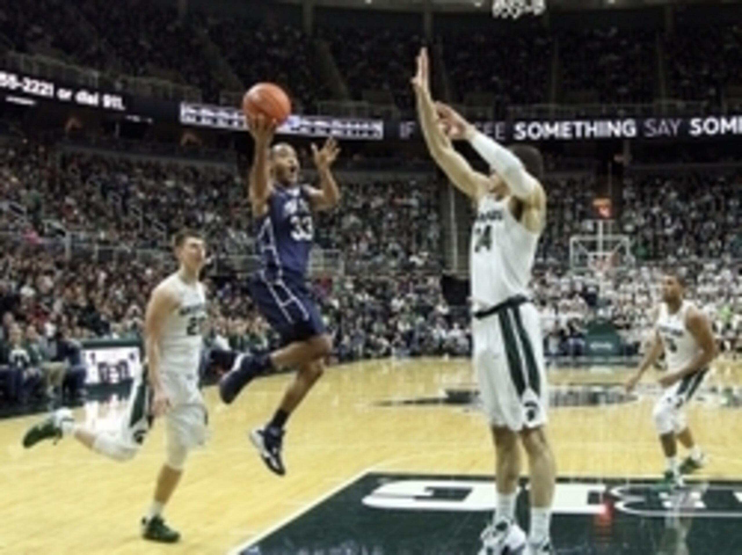 Feb 28, 2016; East Lansing, MI, USA; Penn State Nittany Lions guard Shep Garner (33) drives to the basket against Michigan State Spartans forward Gavin Schilling (34) during the second half of a game at Jack Breslin Student Events Center. Mandatory Credit