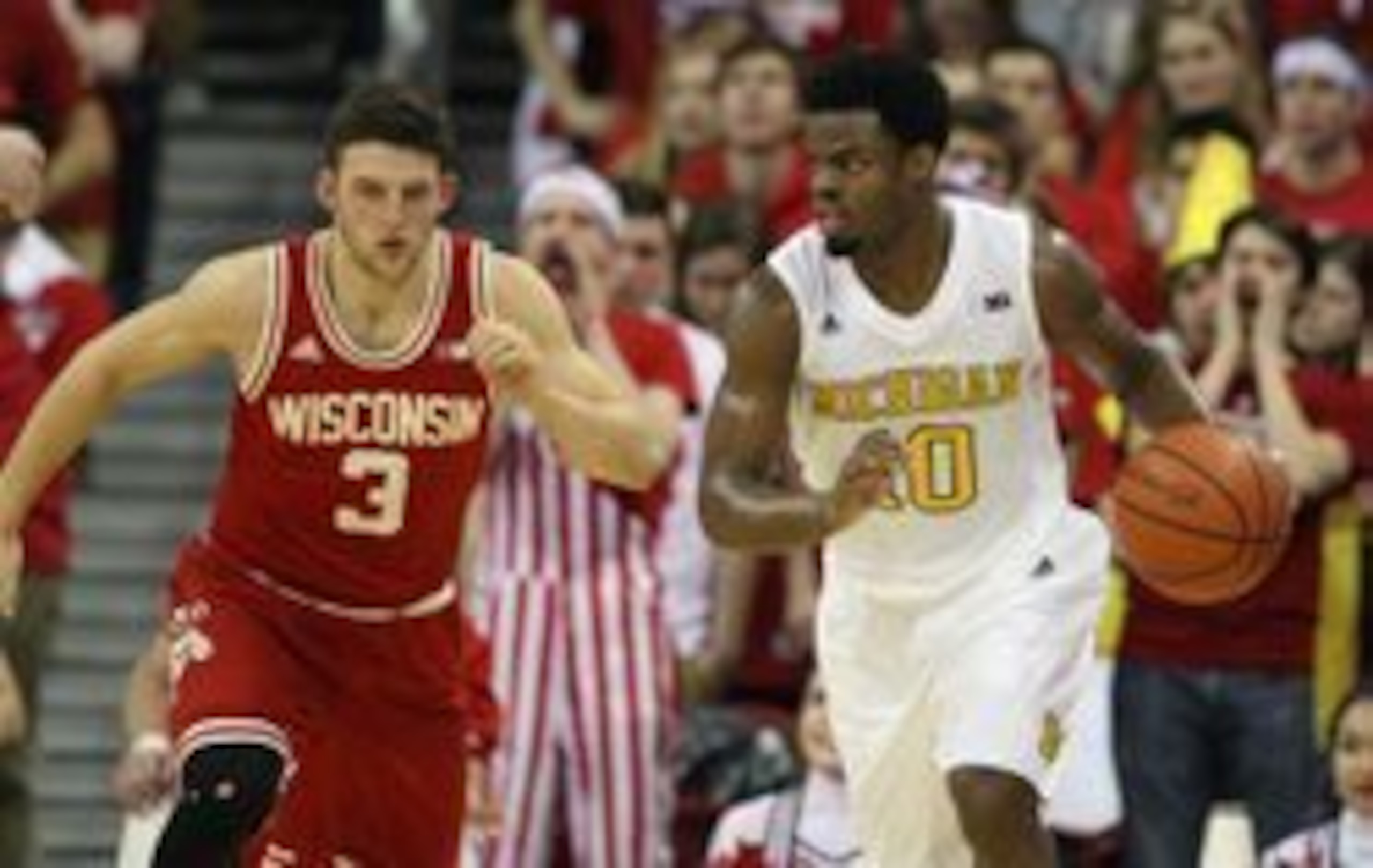 Feb 28, 2016; Madison, WI, USA; Michigan Wolverines guard Derrick Walton Jr.(10) dribbles the ball as Wisconsin Badgers guard Zak Showalter (3) follows at the Kohl Center. Wisconsin defeated Michigan 68-57. Mandatory Credit: Mary Langenfeld-USA TODAY Spor