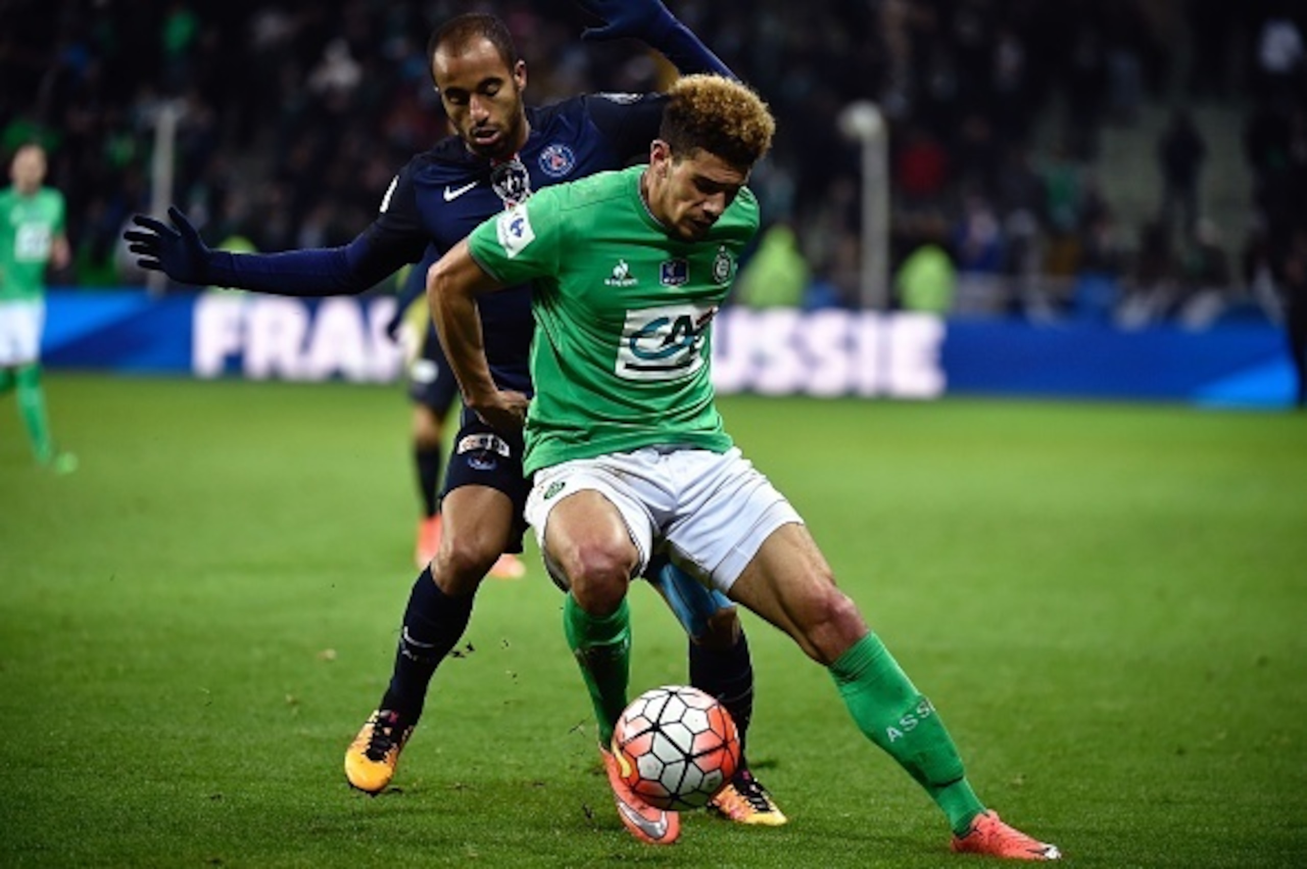 Malcuit holds off Lucas Moura.