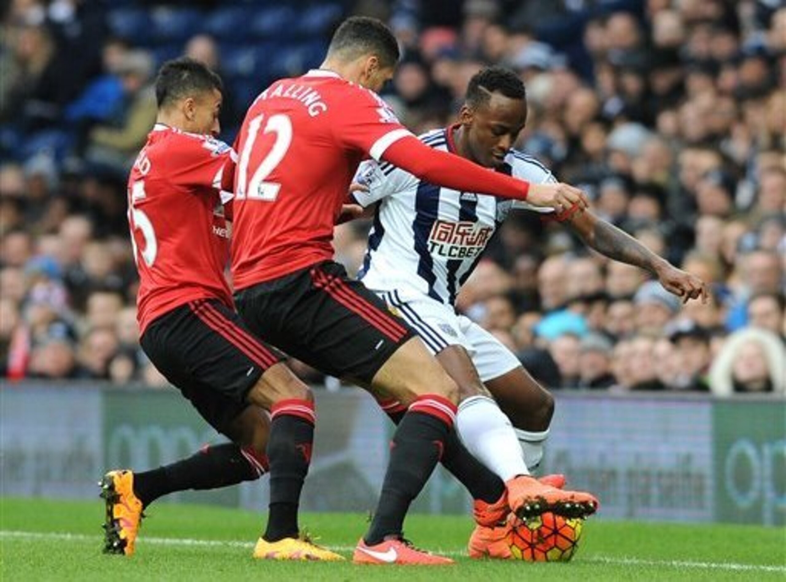 Chris Smalling gets across to make a tackle on West Brom's Saido Berahino.