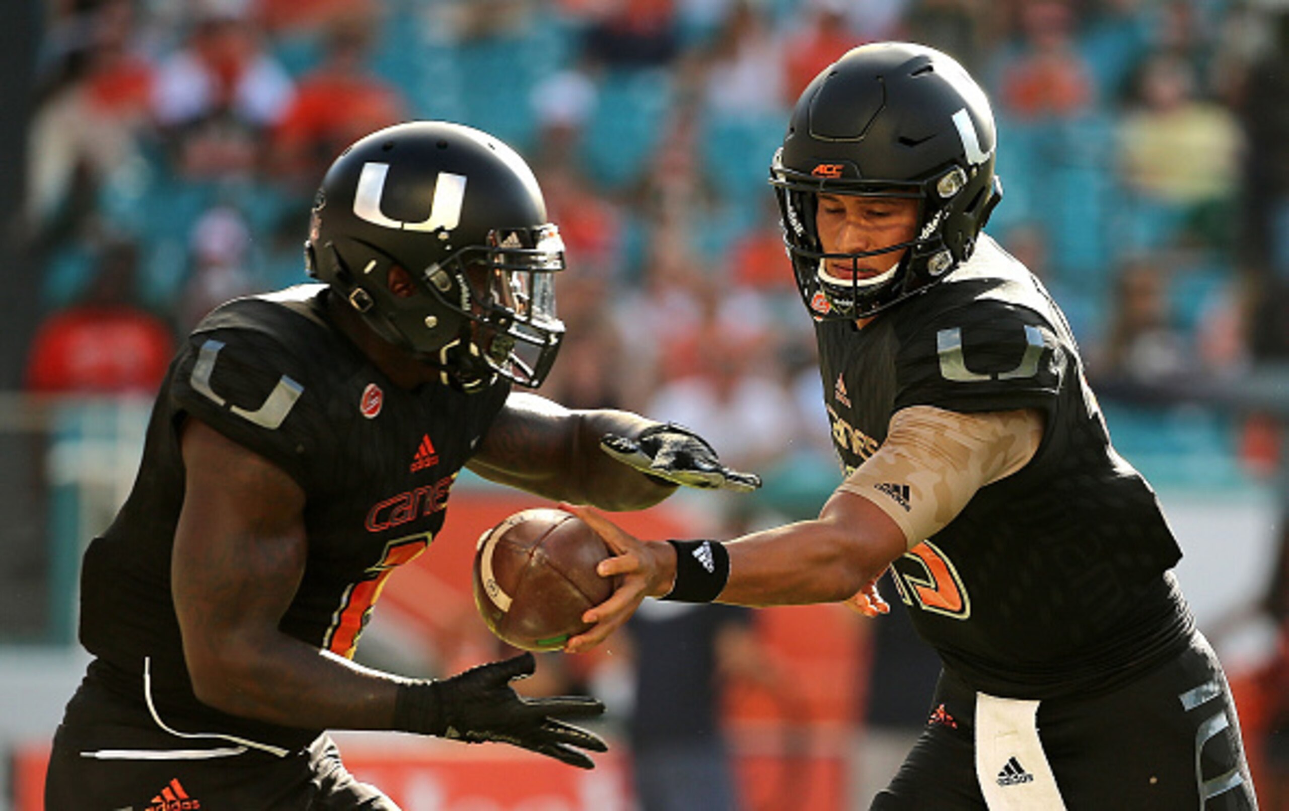 MIAMI GARDENS, FL - NOVEMBER 07: Brad Kaaya #15 hands off to Joseph Yearby #2 of the Miami Hurricanes during a game at Sun Life Stadium on November 7, 2015 in Miami Gardens, Florida. (Photo by Mike Ehrmann/Getty Images) MIAMI GARDENS, FL - NOVEMBER 07: Brad Kaaya #15 hands off to Joseph Yearby #2 of the Miami Hurricanes during a game at Sun Life Stadium on November 7, 2015 in Miami Gardens, Florida. (Photo by Mike Ehrmann/Getty Images)