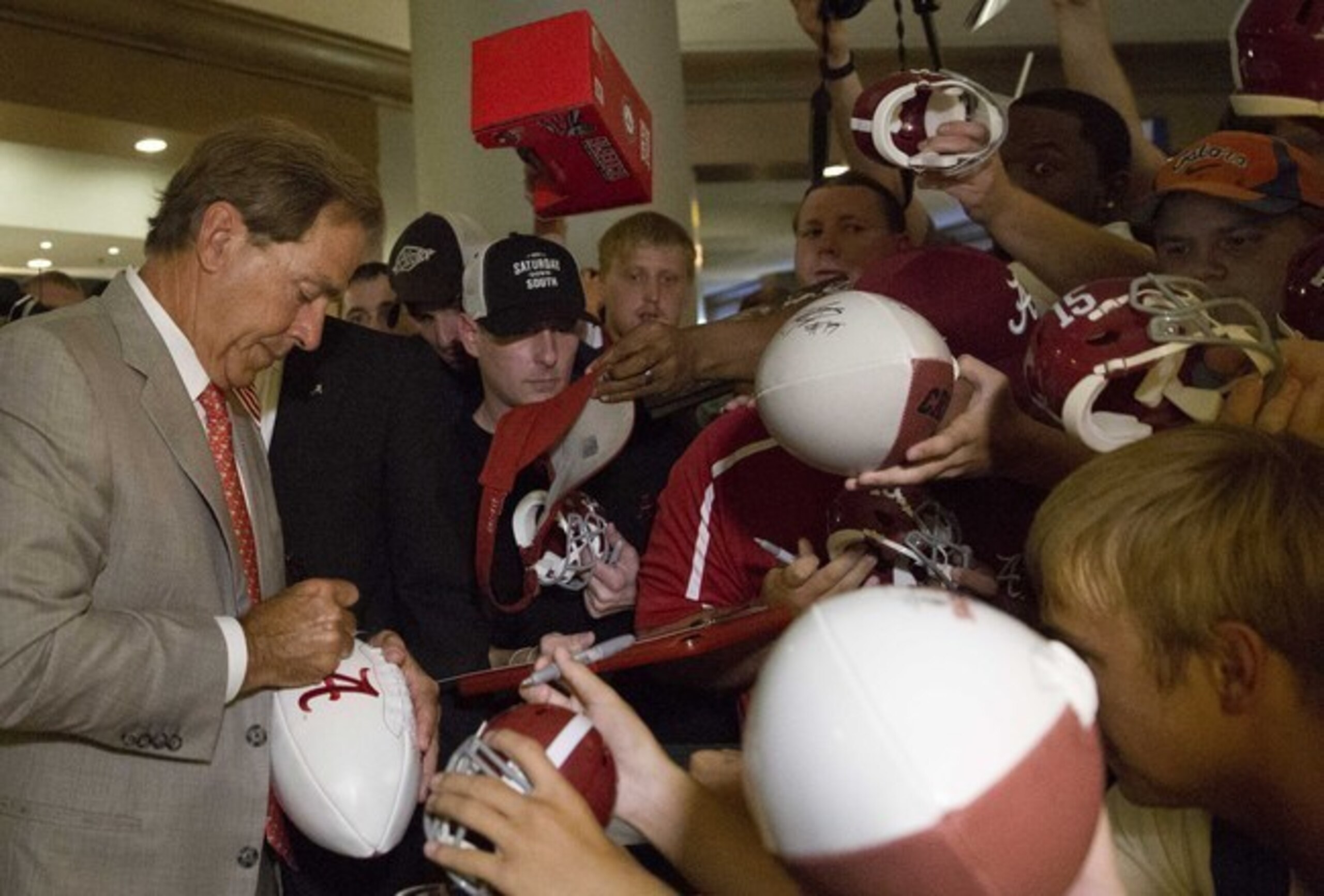 Nick Saban's appearances at SEC media days become a feeding frenzy for autograph hunters.