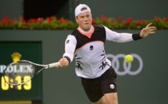 Illya Marchenko hits a forehand during a match at the 2016 BNP Paribas Open.