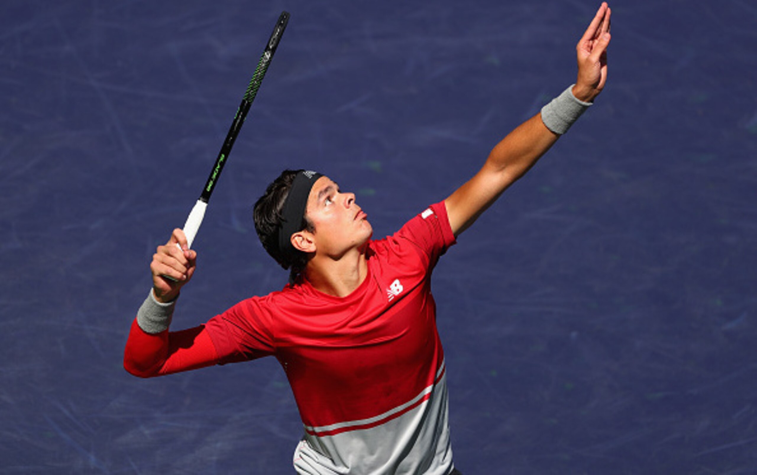 Milos Raonic serves during a match at the BNP Paribas Open.