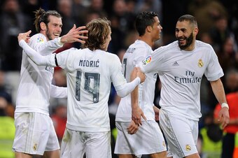 Real Madrid celebrate after Karim Benzema's opening goal against Sevilla.