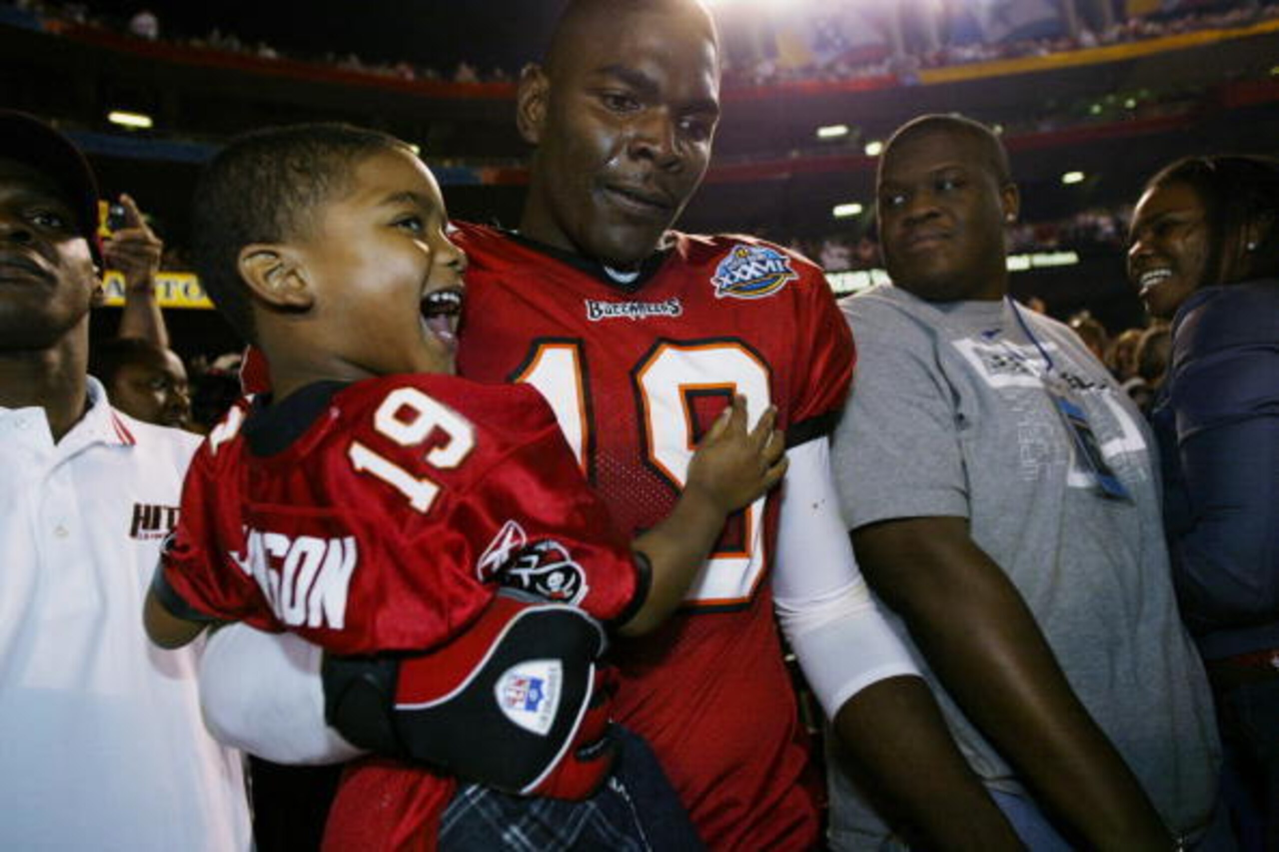 Former Tampa Bay Buccaneers star Keyshawn Johnson carries Keyshawn Jr. after winning Super Bowl 37.