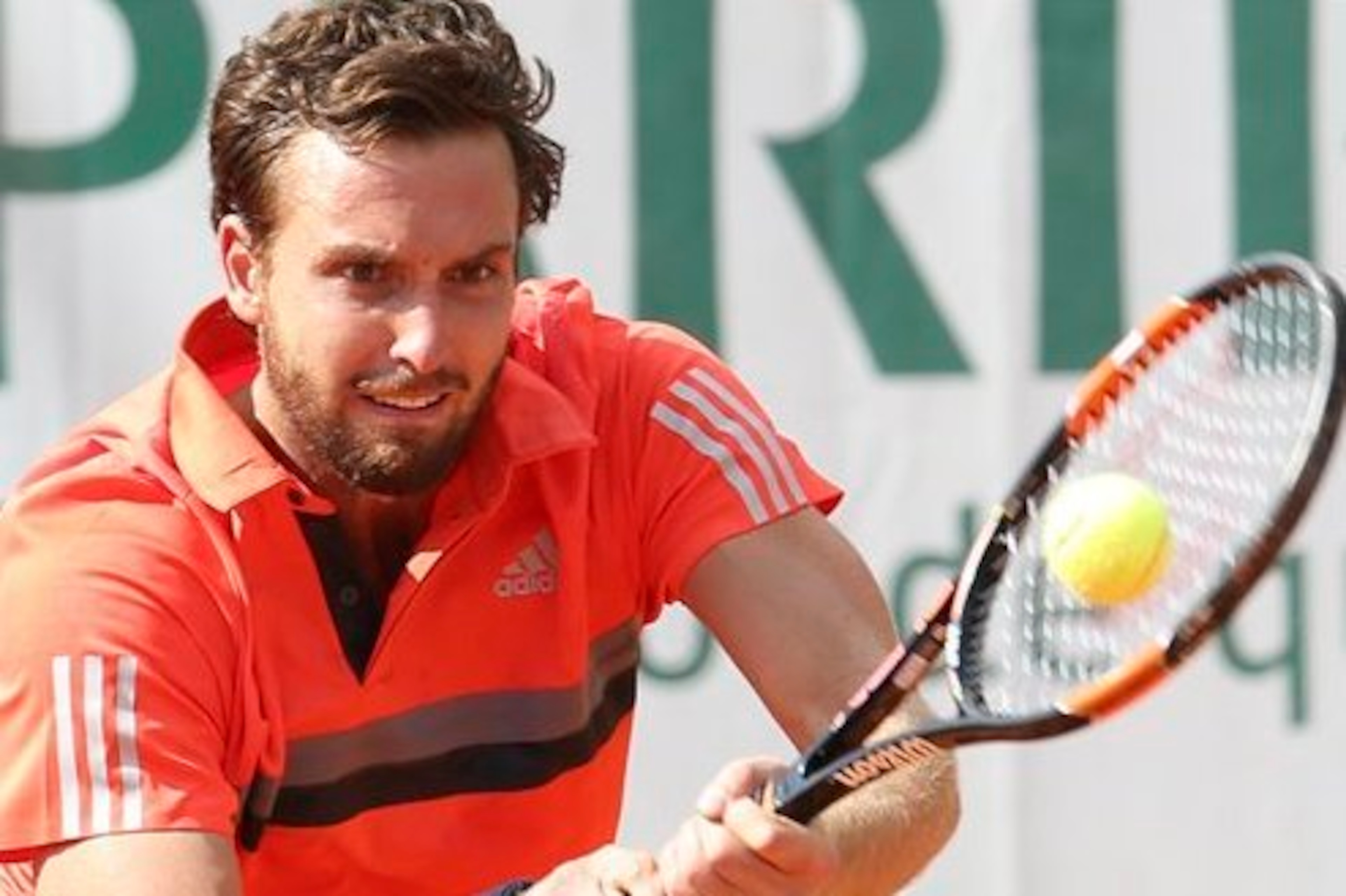 Ernests Gulbis hits a backhand during the 2015 French Open.