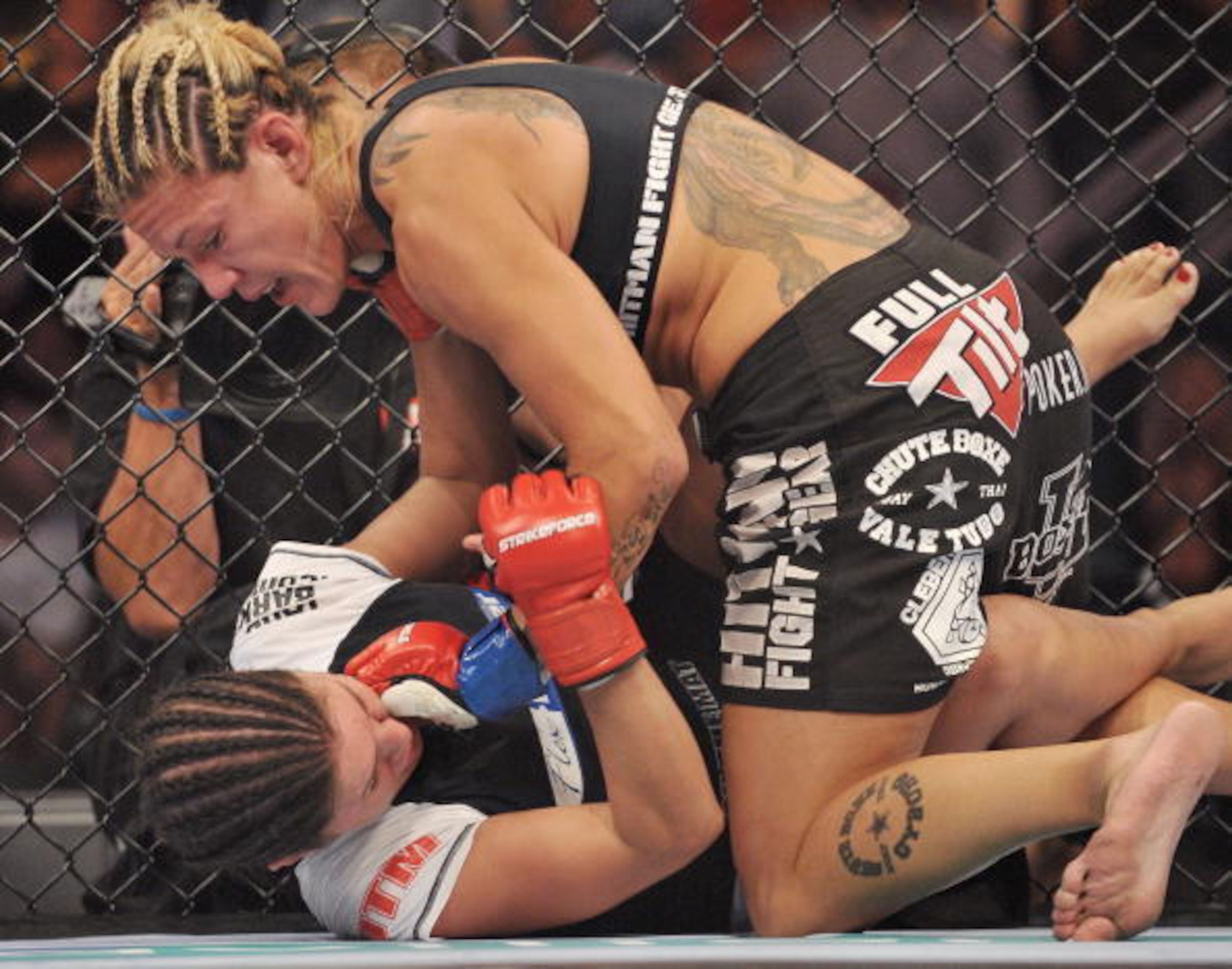 SAN JOSE, CA - AUGUST 15:  Cris Cyborg (Top) battles Gina Carano during their Middleweight Championship fight at Strikeforce: Carano vs. Cyborg on August 15, 2009 in San Jose, California.  (Photo by Jon Kopaloff/Getty Images)