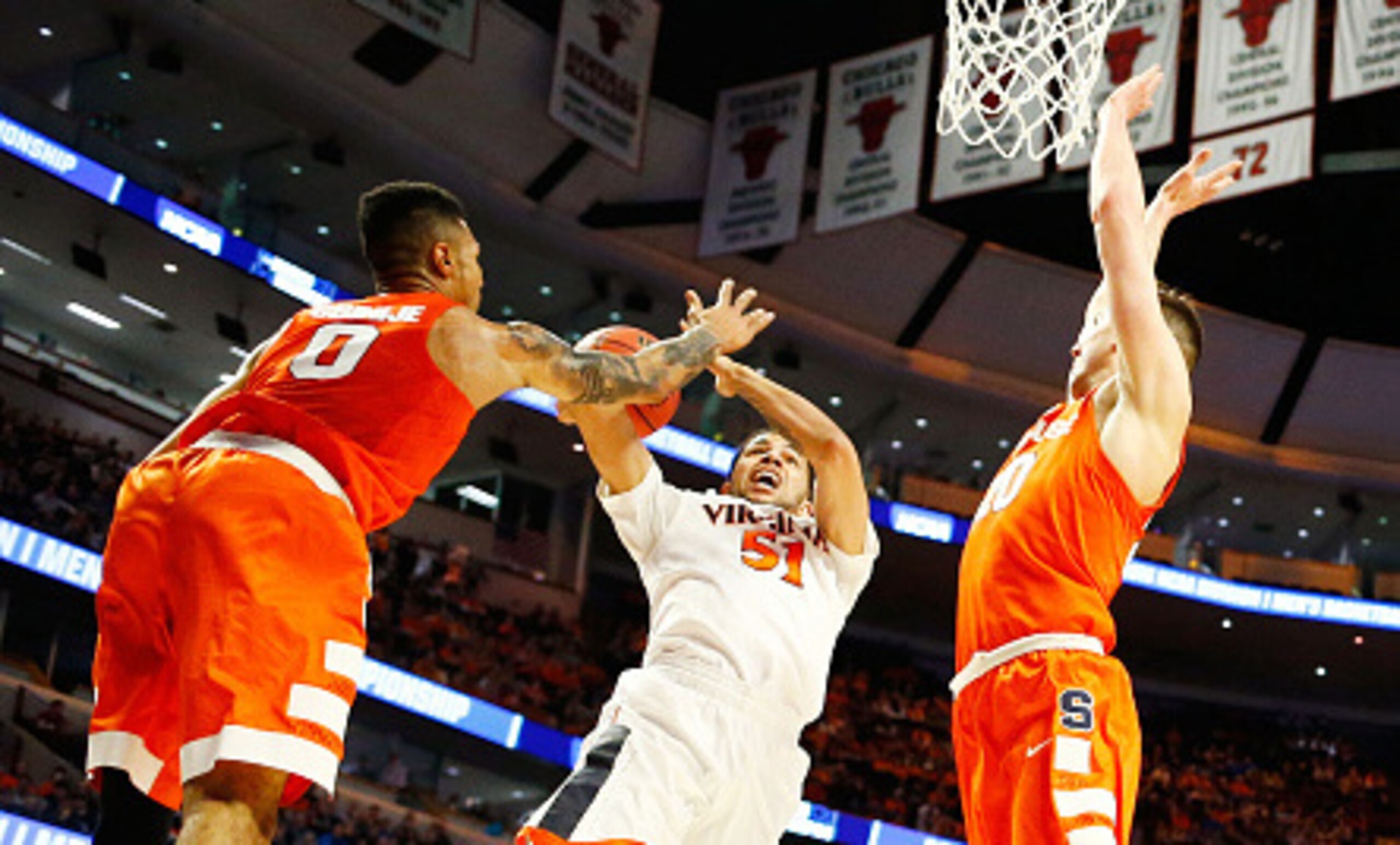 Michael Gbinije (0) and Trevor Cooney (20) contest a shot by Darius Thompson.