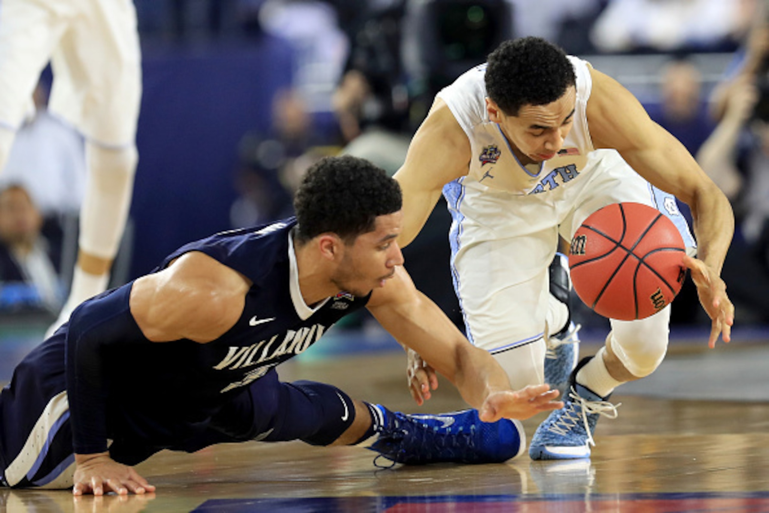 Josh Hart (left) dives for a loss ball against Marcus Paige.