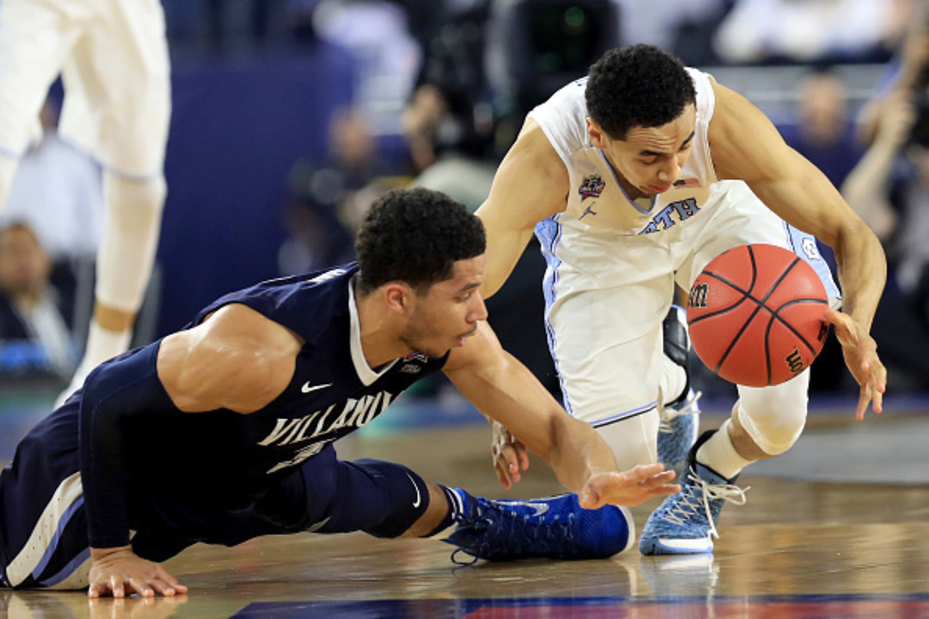 Josh Hart (left) dives for a loss ball against Marcus Paige.