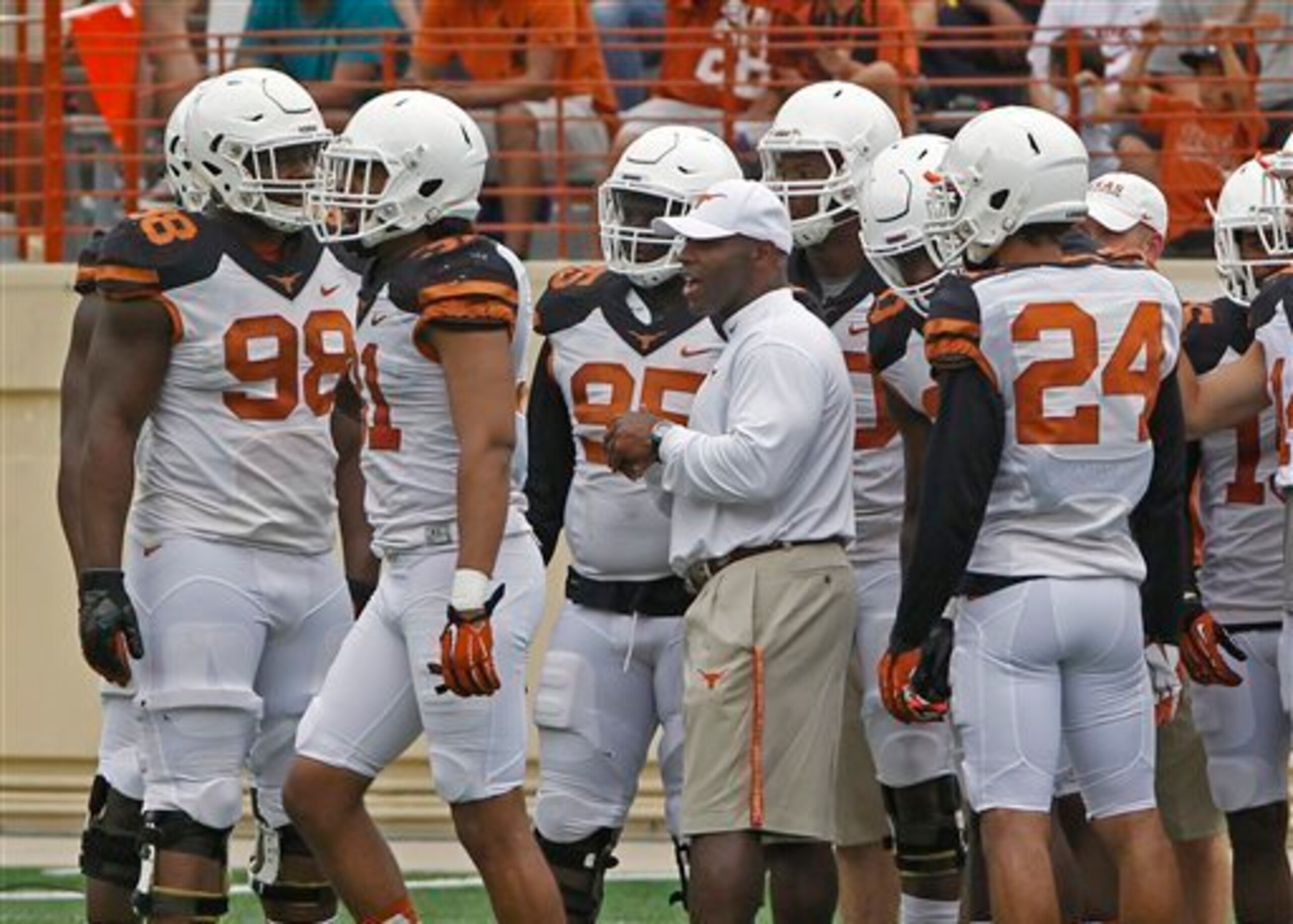 Texas HC Charlie Strong (center)