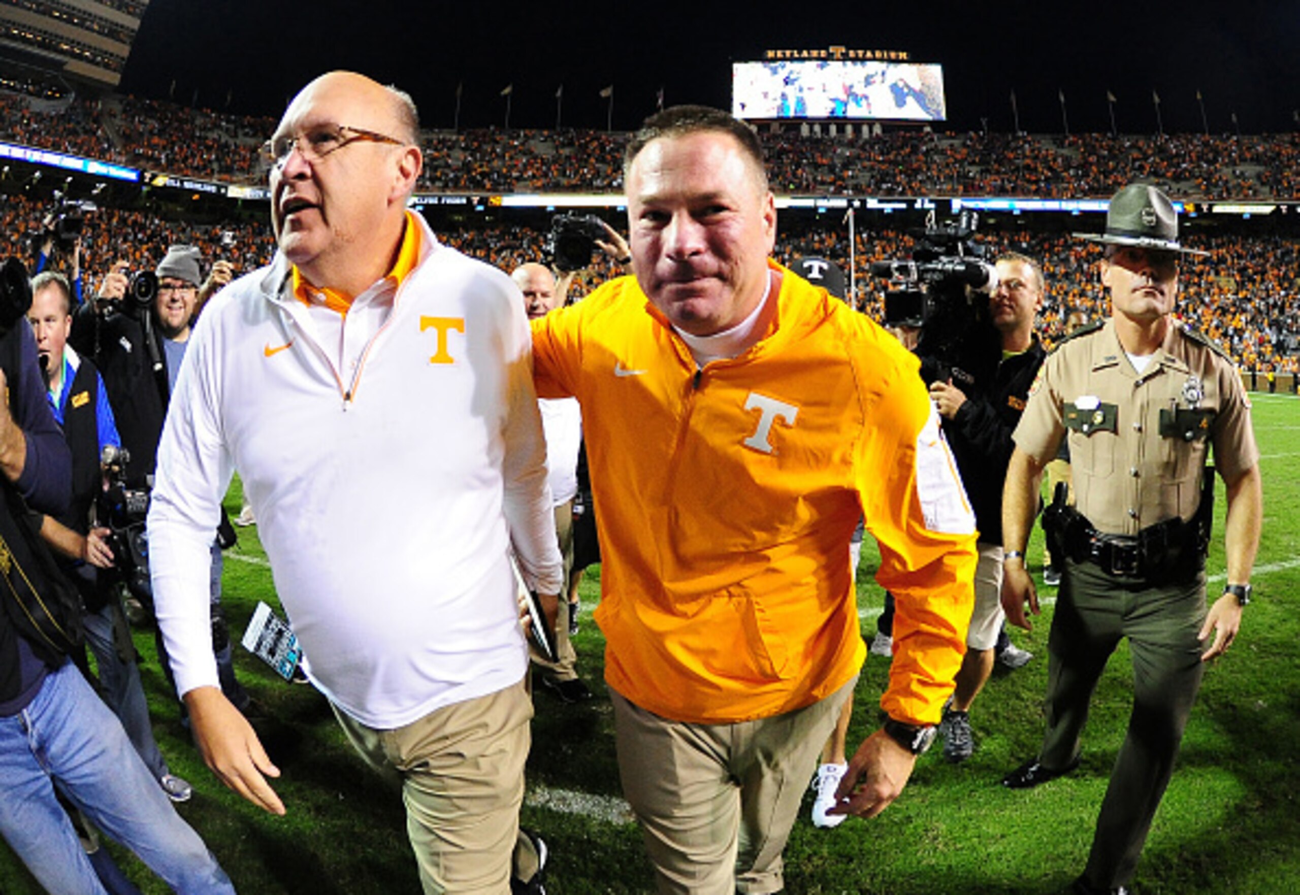 KNOXVILLE, TN - OCTOBER 10: Head Coach Butch Jones (R) of the Tennessee Volunteers celebrates with Offensive Coordintator Mike DeBord after the game against the Georgia Bulldogs on October 10, 2015 at Neyland Stadium in Knoxville, Tennessee. (Photo by Sco