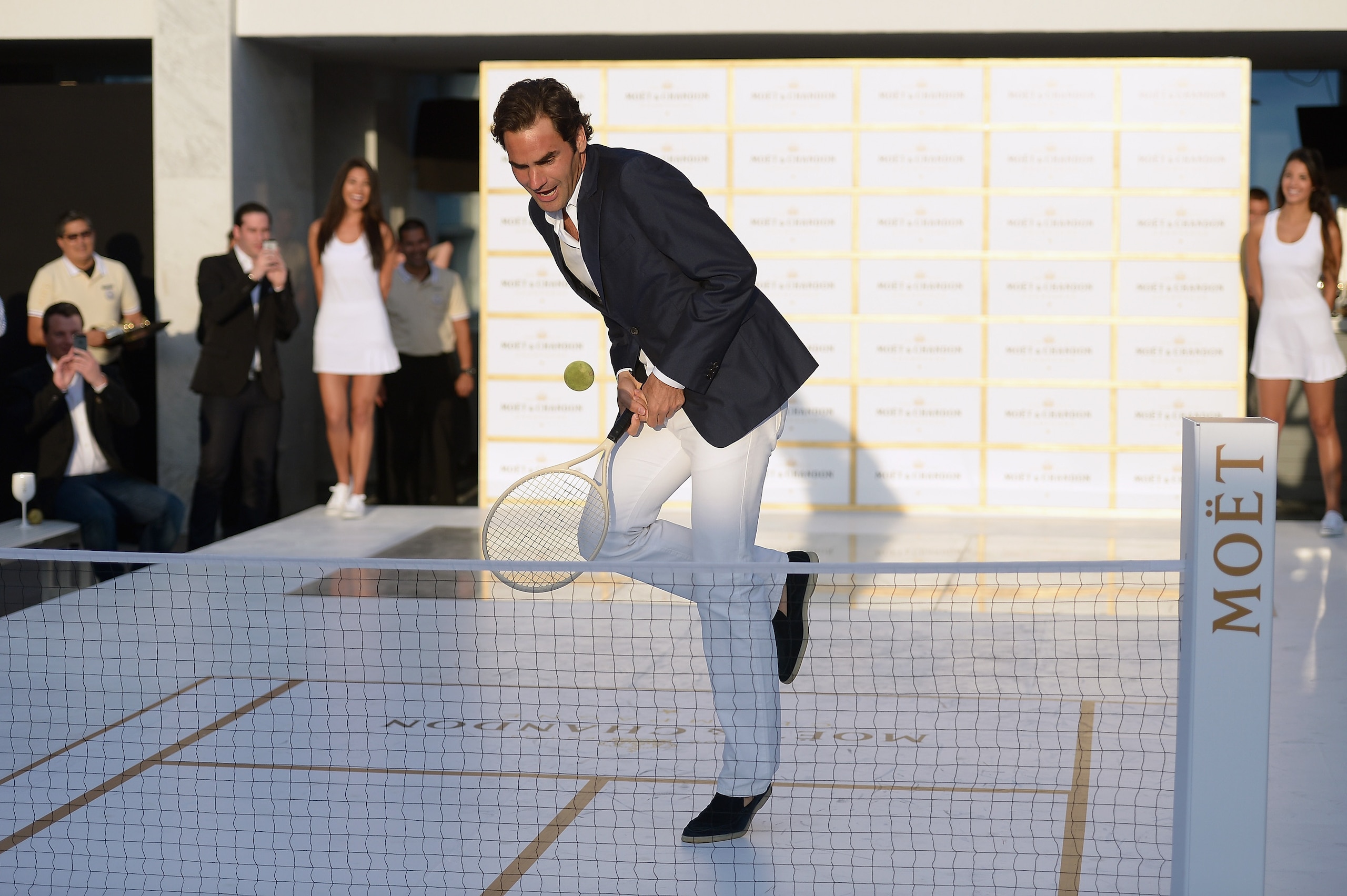 Roger Federer plays tiny tennis at an event for Moet at the 2015 U.S. Open.