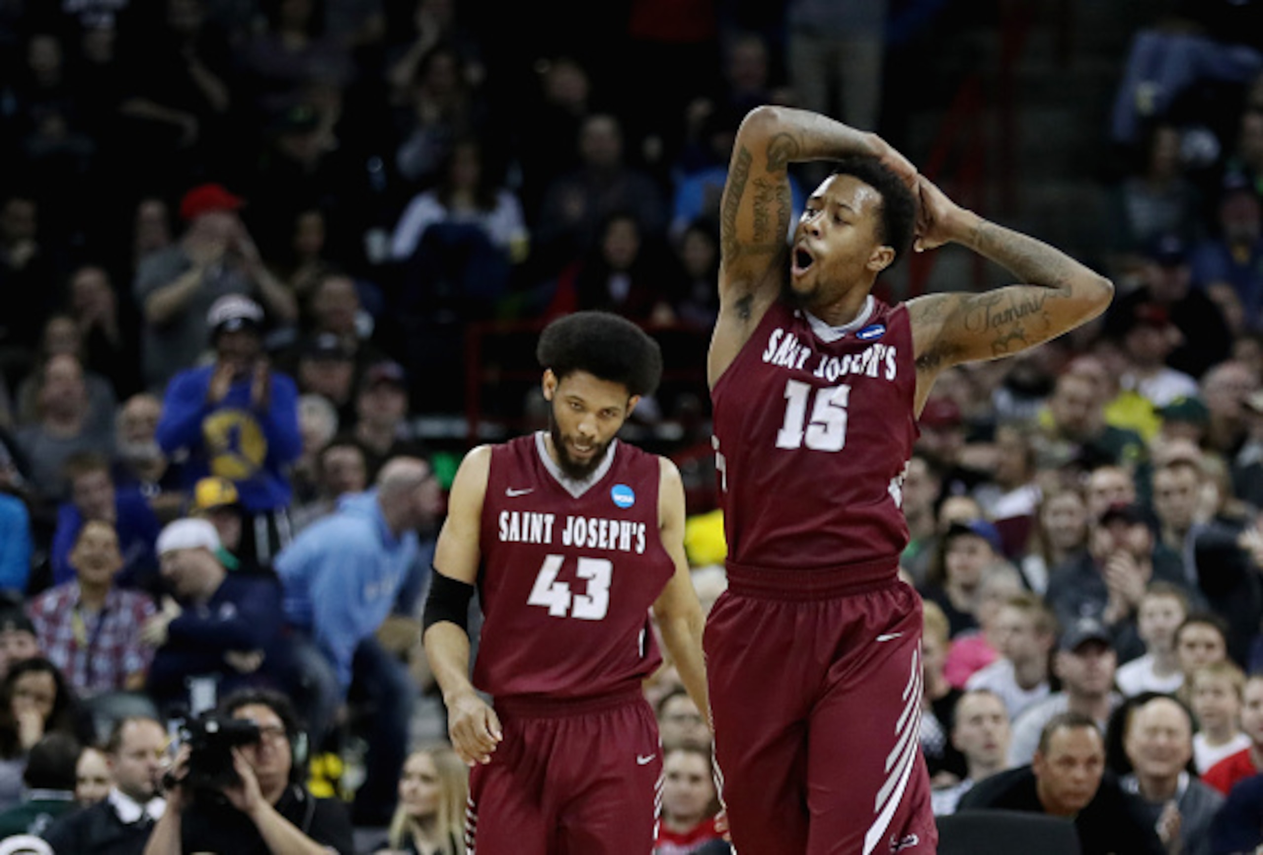 SPOKANE, WA - MARCH 20:  Isaiah Miles #15 of the Saint Joseph's Hawks reacts alongside teammate DeAndre Bembry #43 in the second half against the Oregon Ducks during the second round of the 2016 NCAA Men's Basketball Tournament at Spokane Veterans Memoria