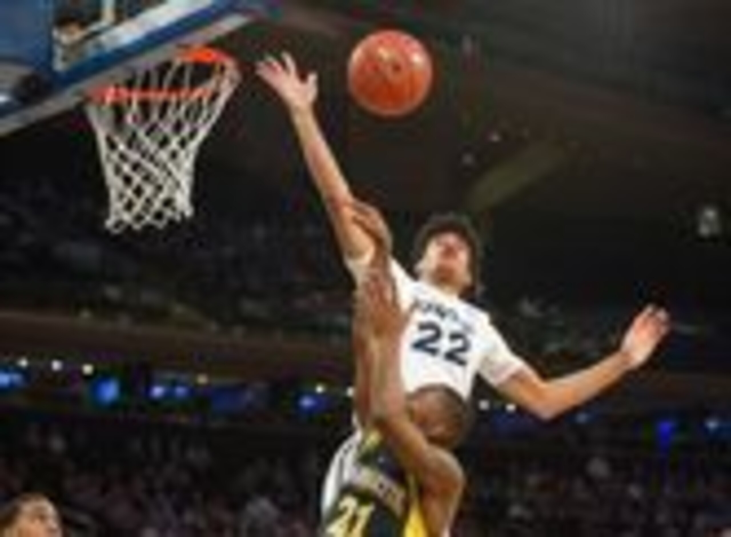Kaiser Gates elevates to reject a Marquette shot attempt.