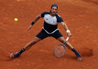 Feliciano Lopez slides into a shot at the 2016 Barcelona Open.