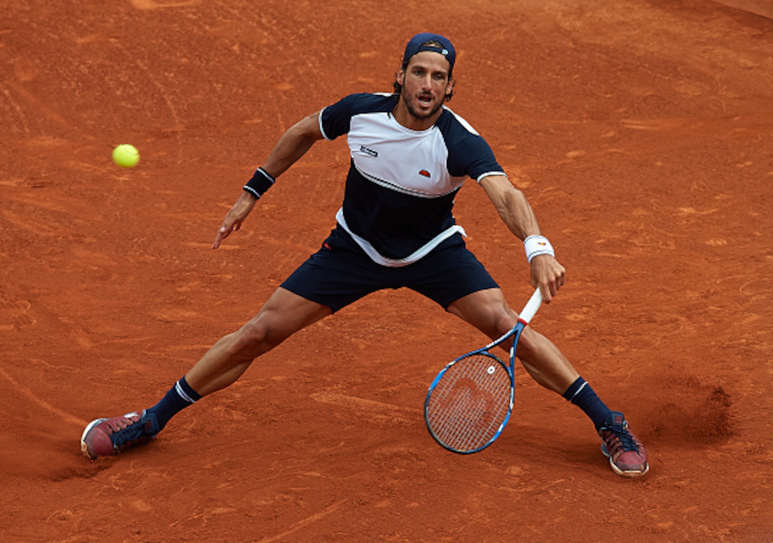 Feliciano Lopez slides into a shot at the 2016 Barcelona Open.