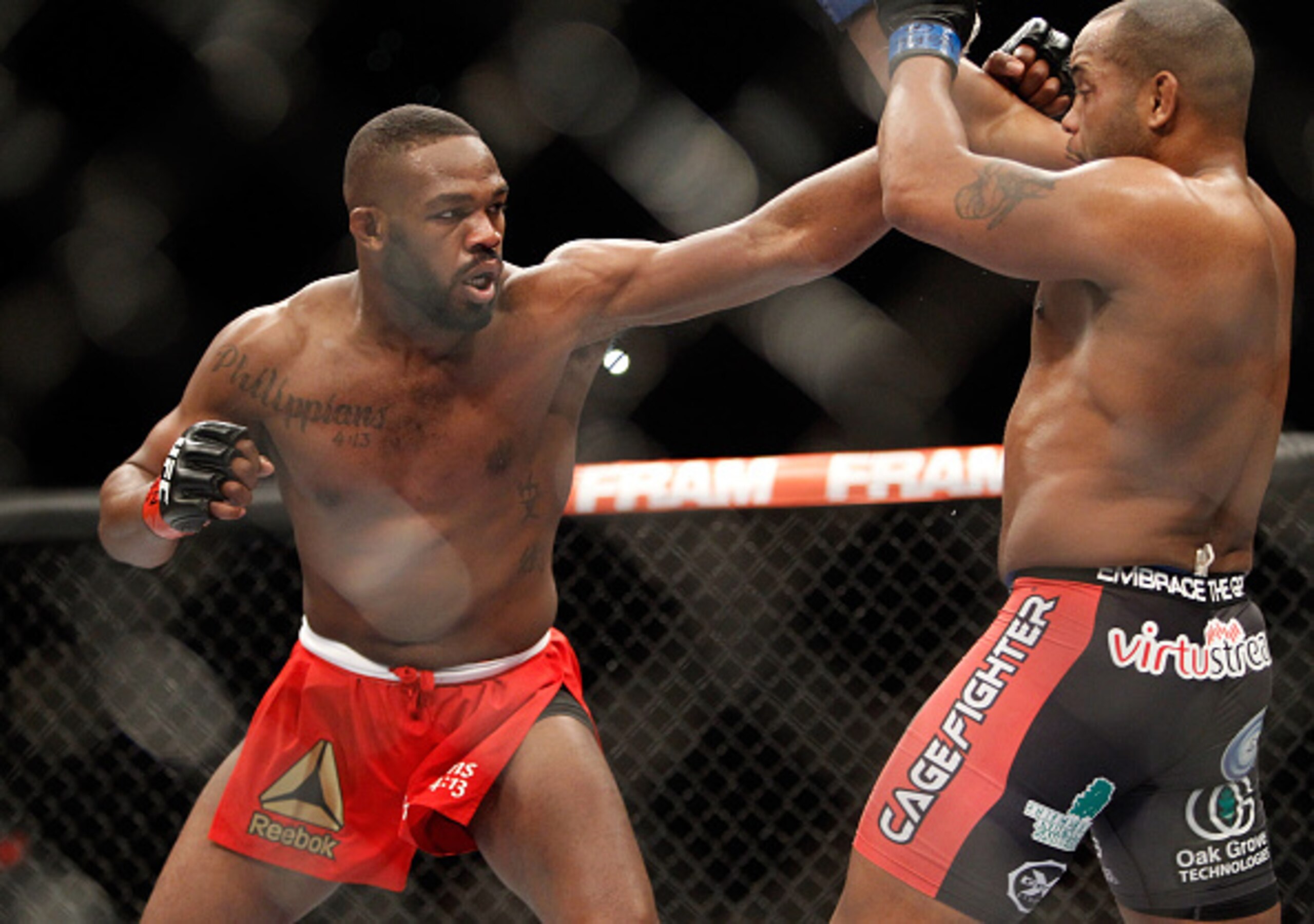 Jon Jones throws a left at Daniel Cormier. Jon Jones throws a left at Daniel Cormier.