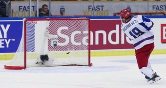 Russia's Pavel Buchnevich scores the 3 - 5 in the empty goal after the team of the US took out their goalie in the final minute of the World Junior Ice Hockey Championships quarter final match between USA and Russia in Malmo, Sweden on January 2, 2014.   