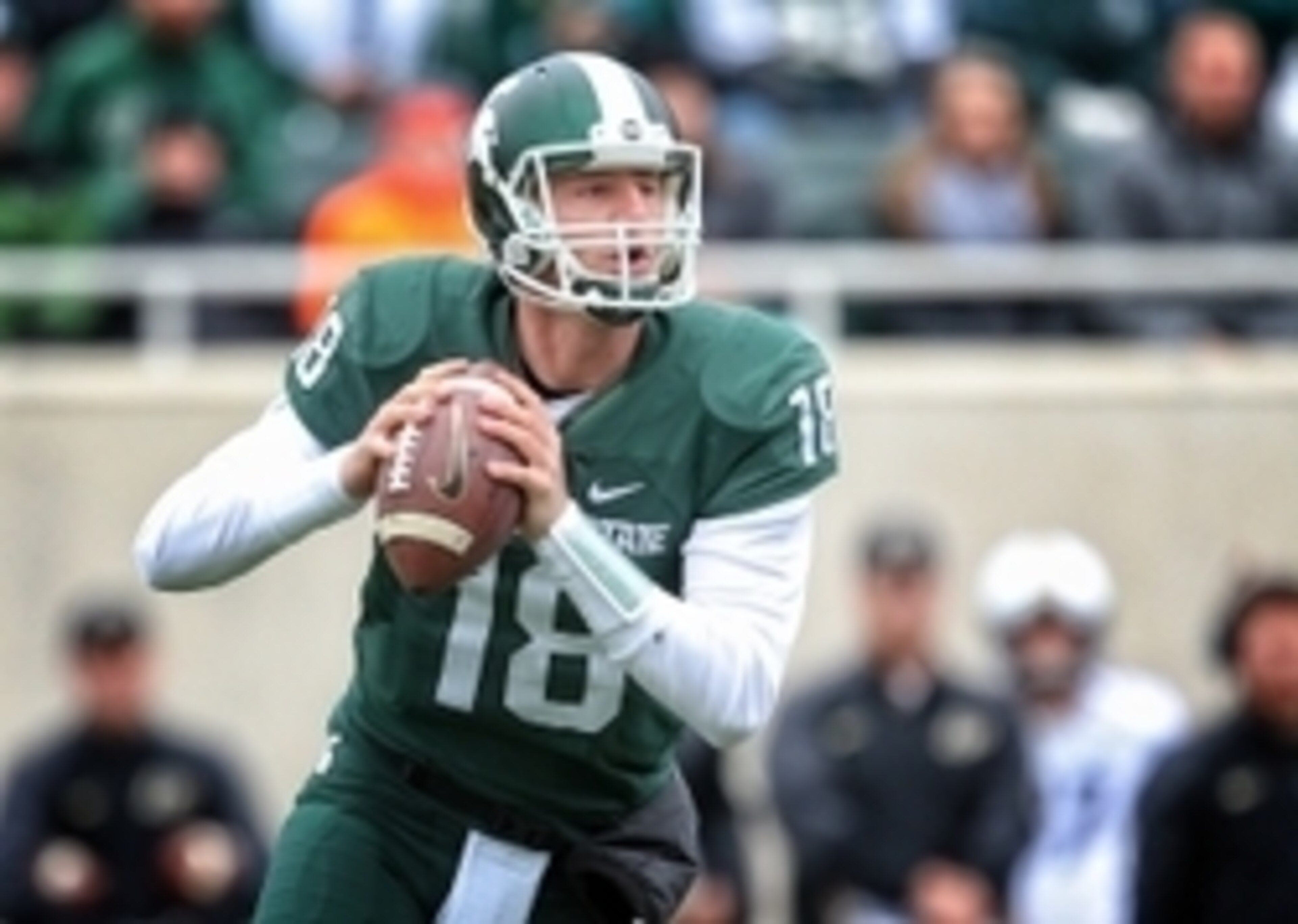 Oct 3, 2015; East Lansing, MI, USA; Michigan State Spartans quarterback Connor Cook (18) scrambles out of the pocket against the Purdue Boilermakers during the 1st quarter of a game at Spartan Stadium. Mandatory Credit: Mike Carter-USA TODAY Sports