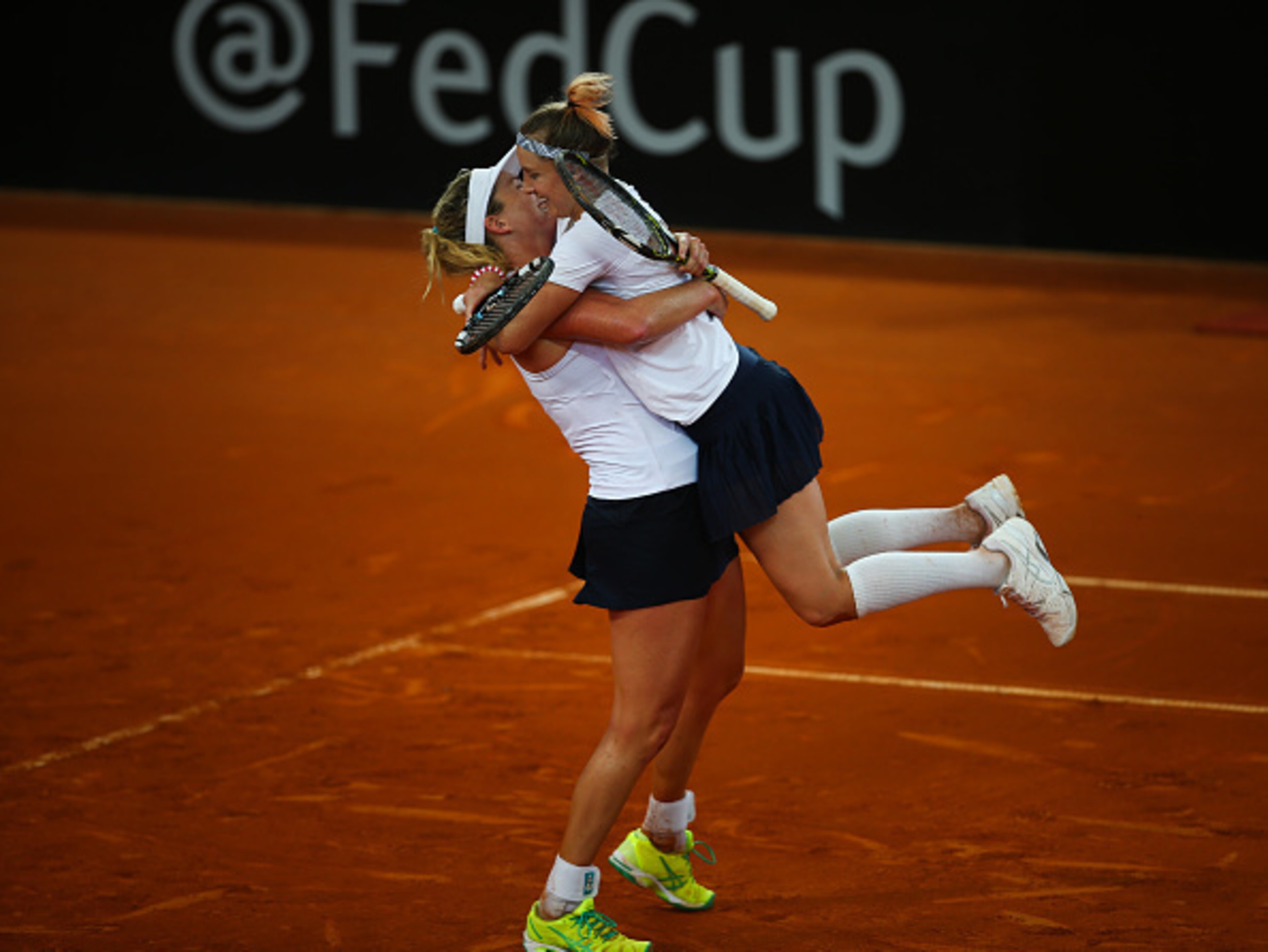 Coco Vandeweghe lifts Bethanie Mattek-Sands after their 2016 Fed Cup win over Great Britain.