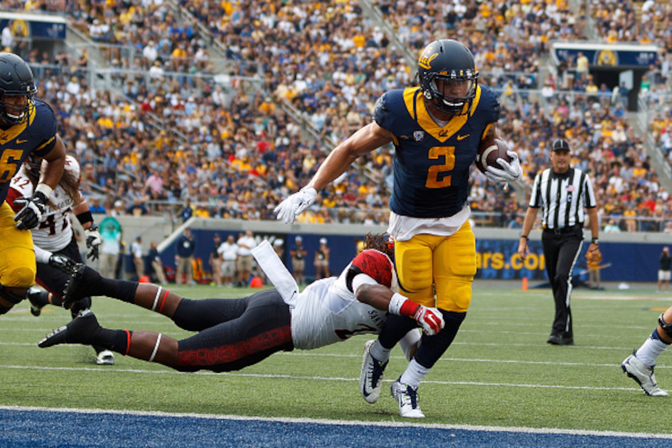 BERKELEY, CA - SEPTEMBER 12:  Running back Daniel Lasco #2 of the California Golden Bears scores a touchdown past defensive back Na'im McGee #21 of the San Diego State Aztecs during the third quarter at California Memorial Stadium on September 12, 2015 in