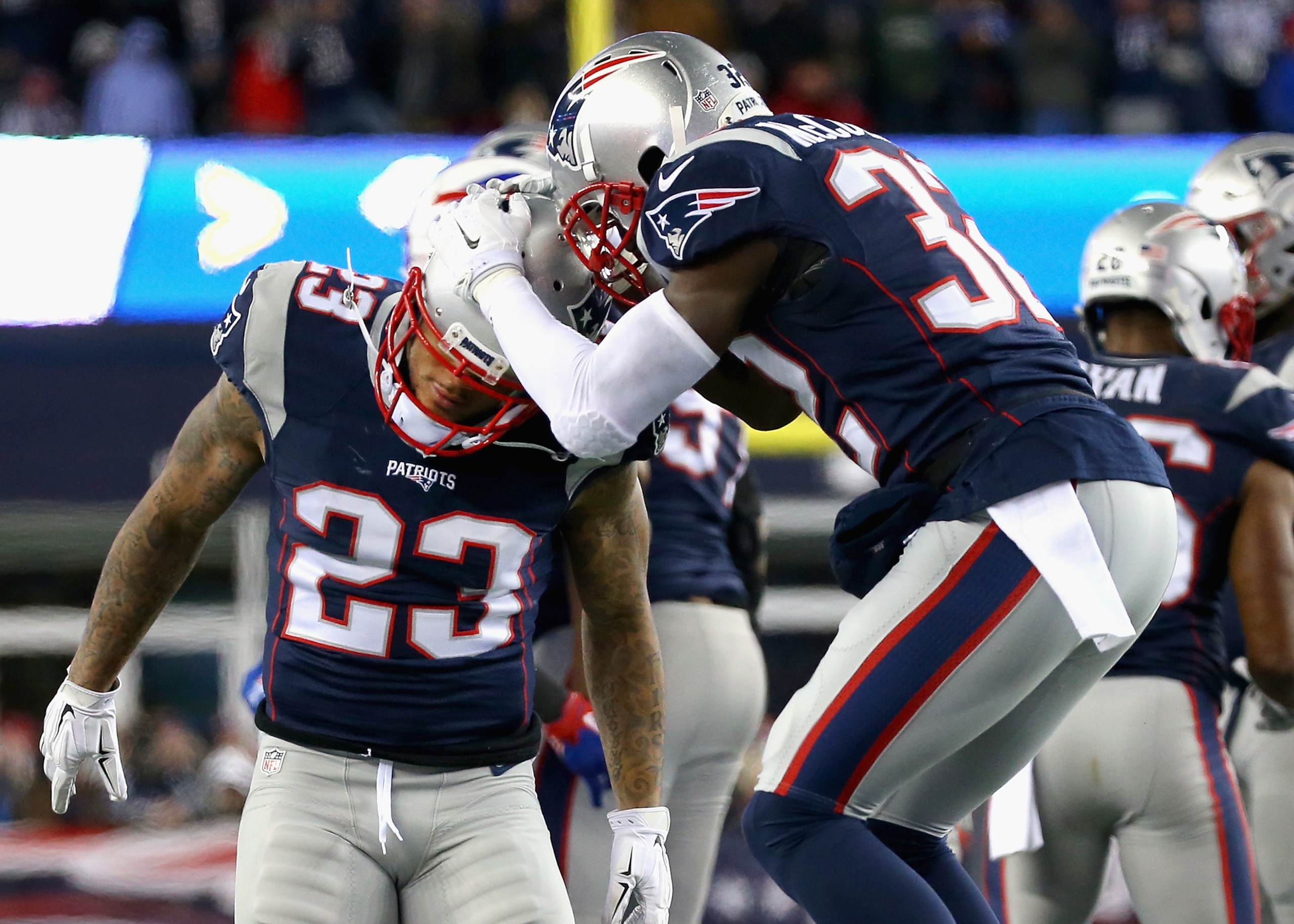 Patrick Chung (23) and Devin McCourty