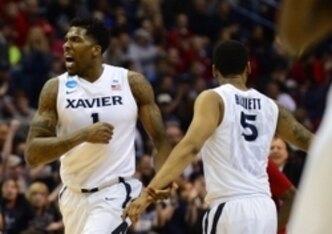 Jalen Reynolds (1) and Trevon Bluiett (5)