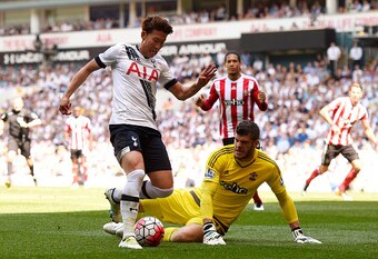 Son Heung-Min rounds Fraser Forster on his way to scoring the game's first goal.