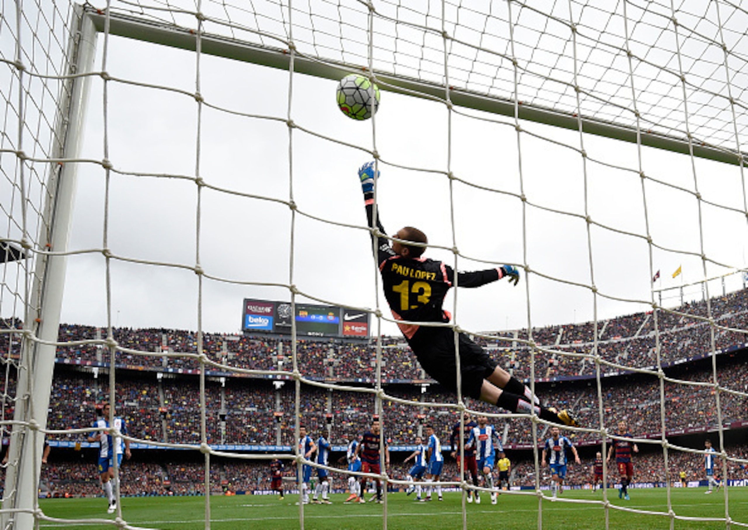 Pau Lopez is unable to stop Lionel Messi's free-kick from finding the net. Pau Lopez is unable to stop Lionel Messi's free-kick from finding the net.