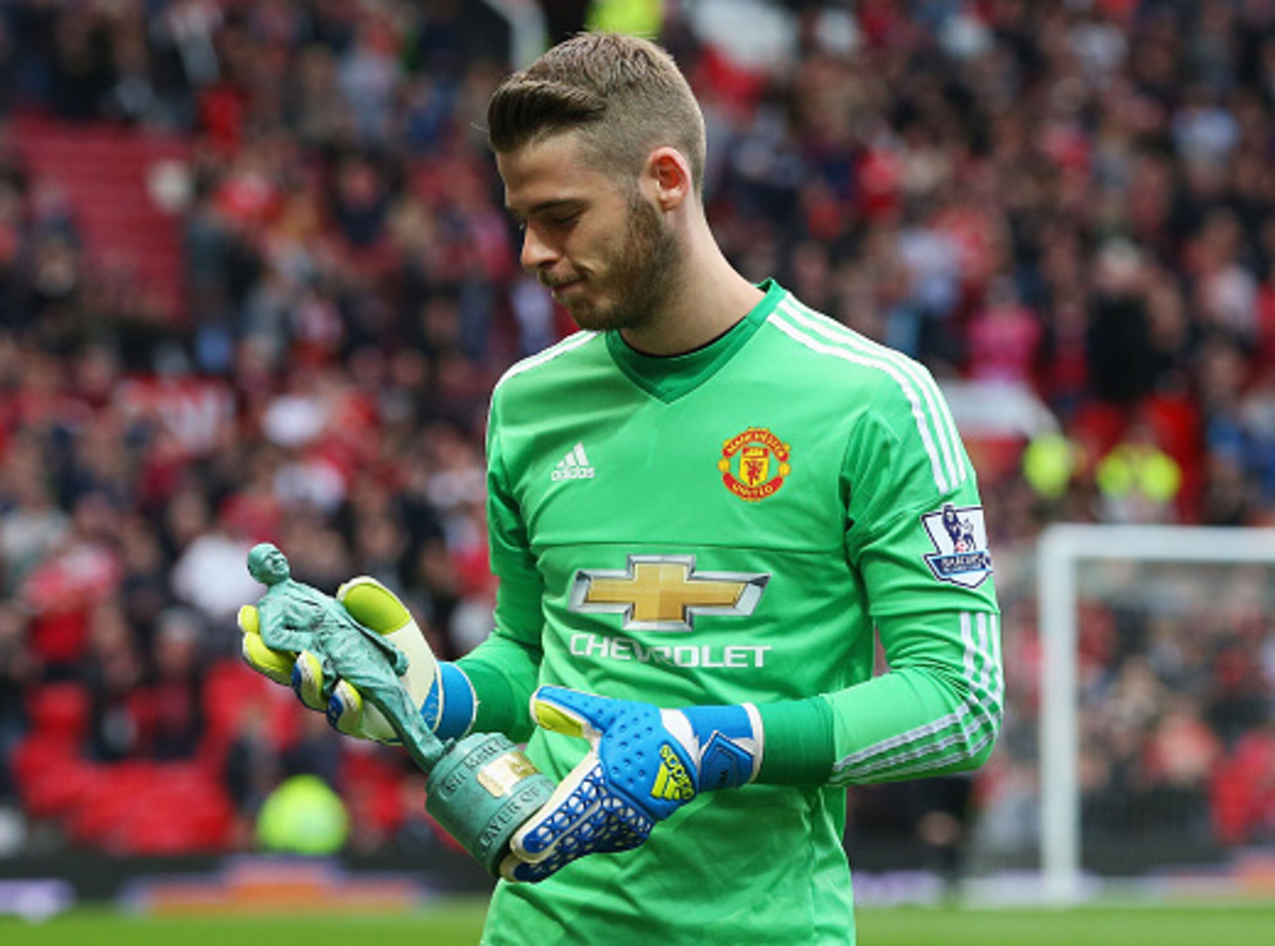 MANCHESTER, ENGLAND - MAY 17:  David De Gea of Manchester United poses with the player of the year trophy prior to the Barclays Premier League match between Manchester United and AFC Bournemouth at Old Trafford on May 17, 2016 in Manchester, England.  (Ph