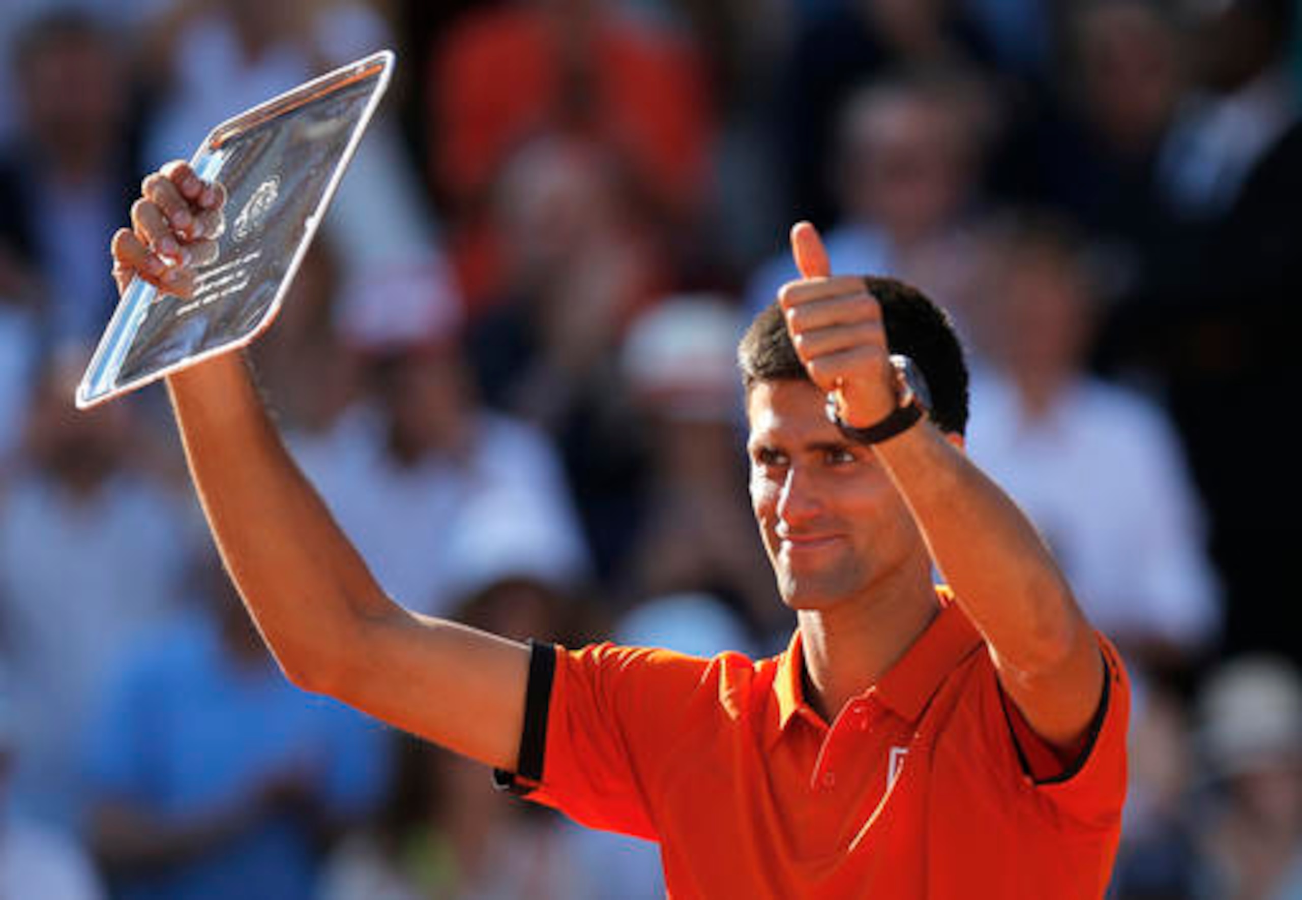 Novak Djokovic shows off the runner-up trophy at the 2015 French Open.