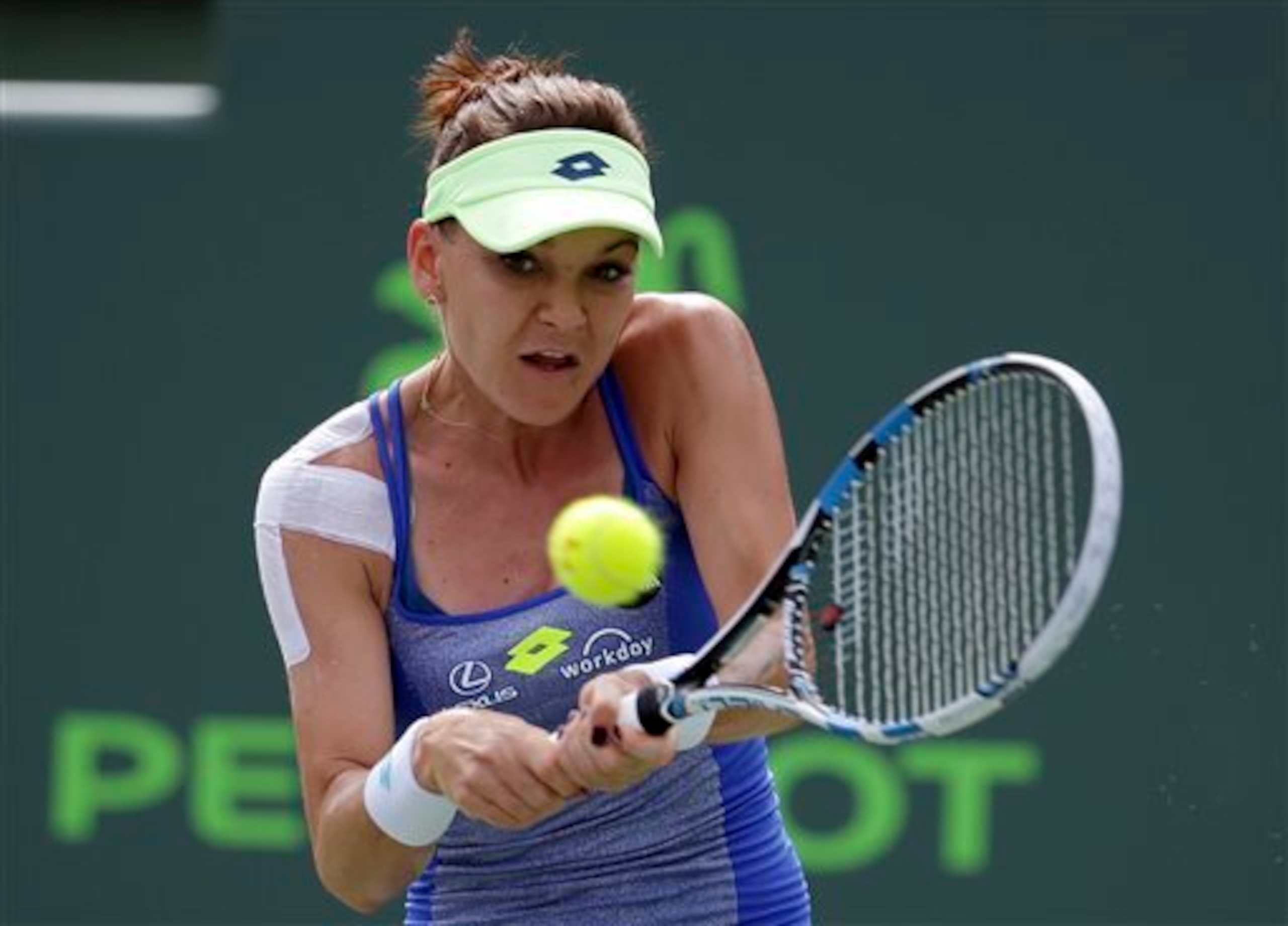 Agnieszka Radwanska hits a backhand at the 2016 Miami Open.