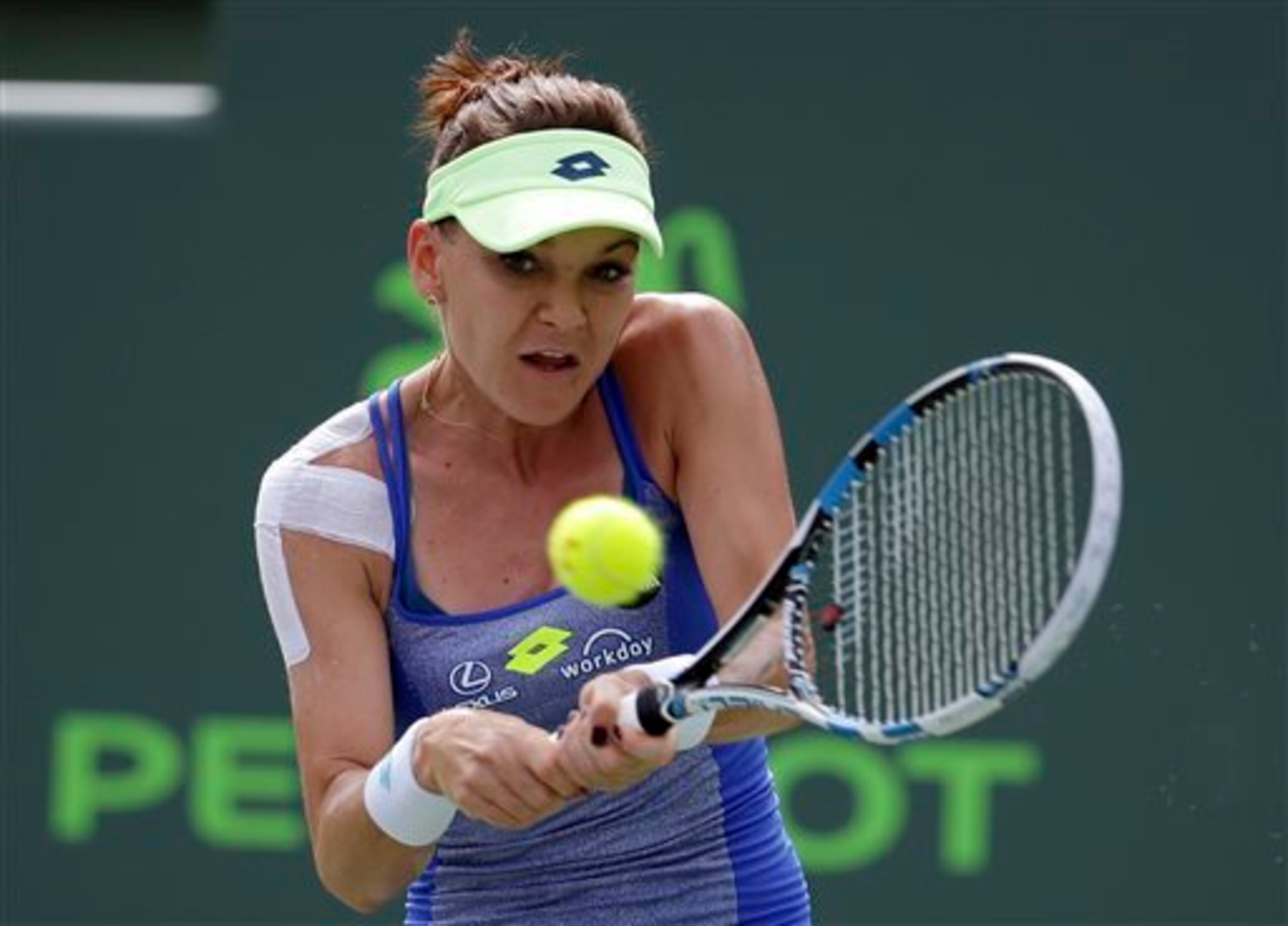 Agnieszka Radwanska hits a backhand at the 2016 Miami Open.