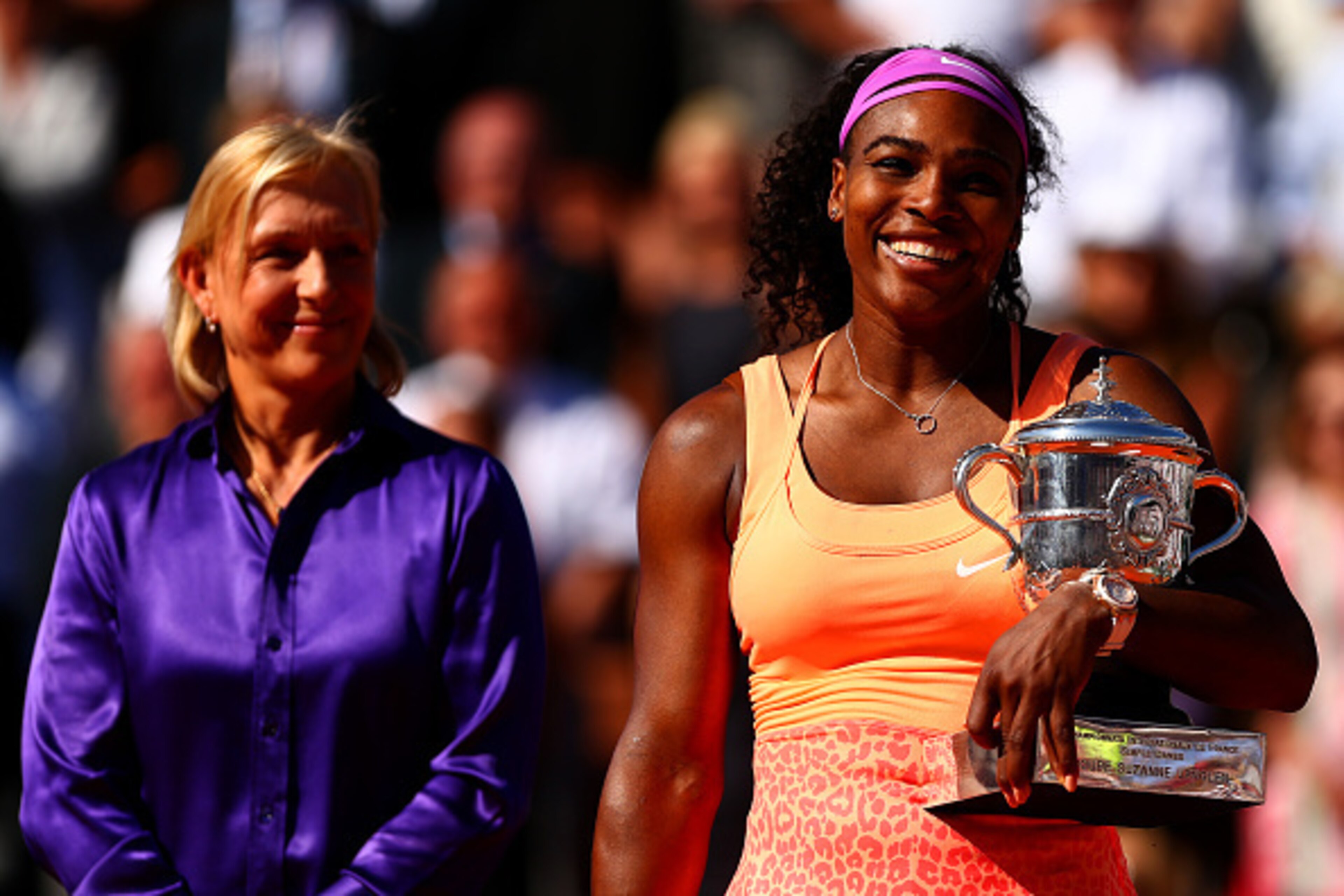 Martina Navratilova looks on as Serena Williams accepts trophy for winning the 2015 French Open.