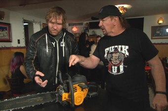 Terry Funk gives Dean Ambrose a present.
