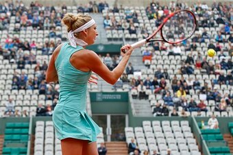 Timea Bacsinszky hits a forehand during a match at the 2016 French Open.