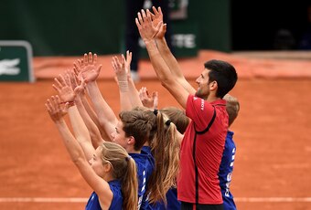 Novak Djokovic has fun with ball kids during the 2016 French Open.