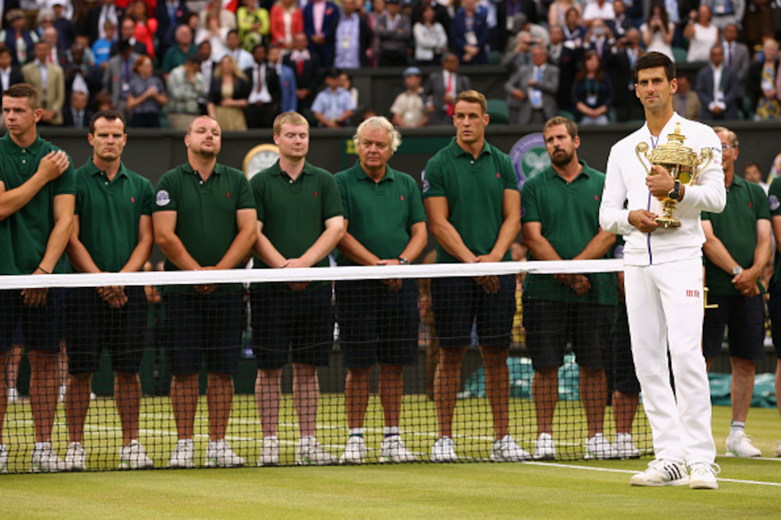 Novak Djokovic stands with the trophy after winning the 2015 Wimbledon championships.
